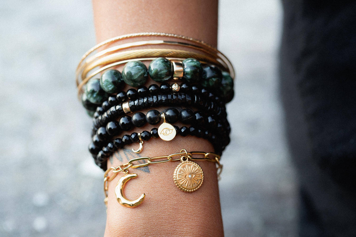 Black Onyx bracelet with 14K gold accents from Earthly Abundance, featuring polished black onyx beads and elegant gold clasp.