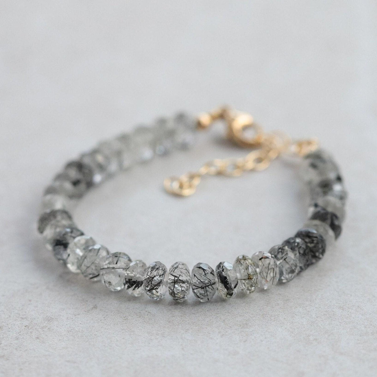 Magnetic black rutilated quartz bracelet from Earthly Abundance featuring polished black quartz with golden rutile inclusions.
