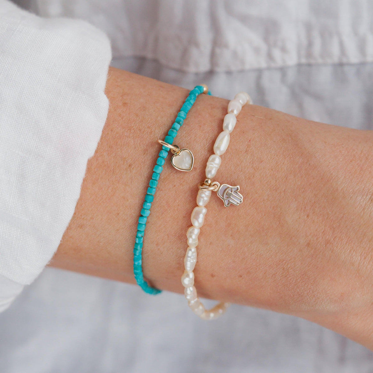 Freshwater pearl bracelet by Earthly Abundance featuring lustrous pearls on a delicate clasped chain.