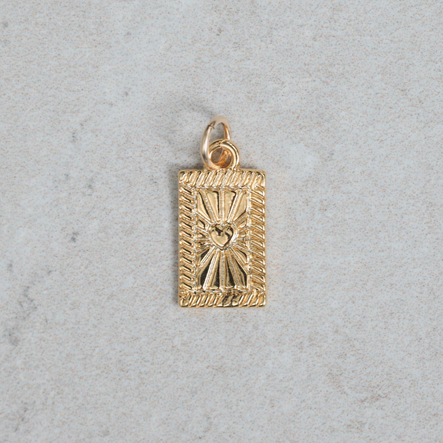 Gold vermeil pendant from Earthly Abundance featuring a detailed, elegant design on a delicate chain.