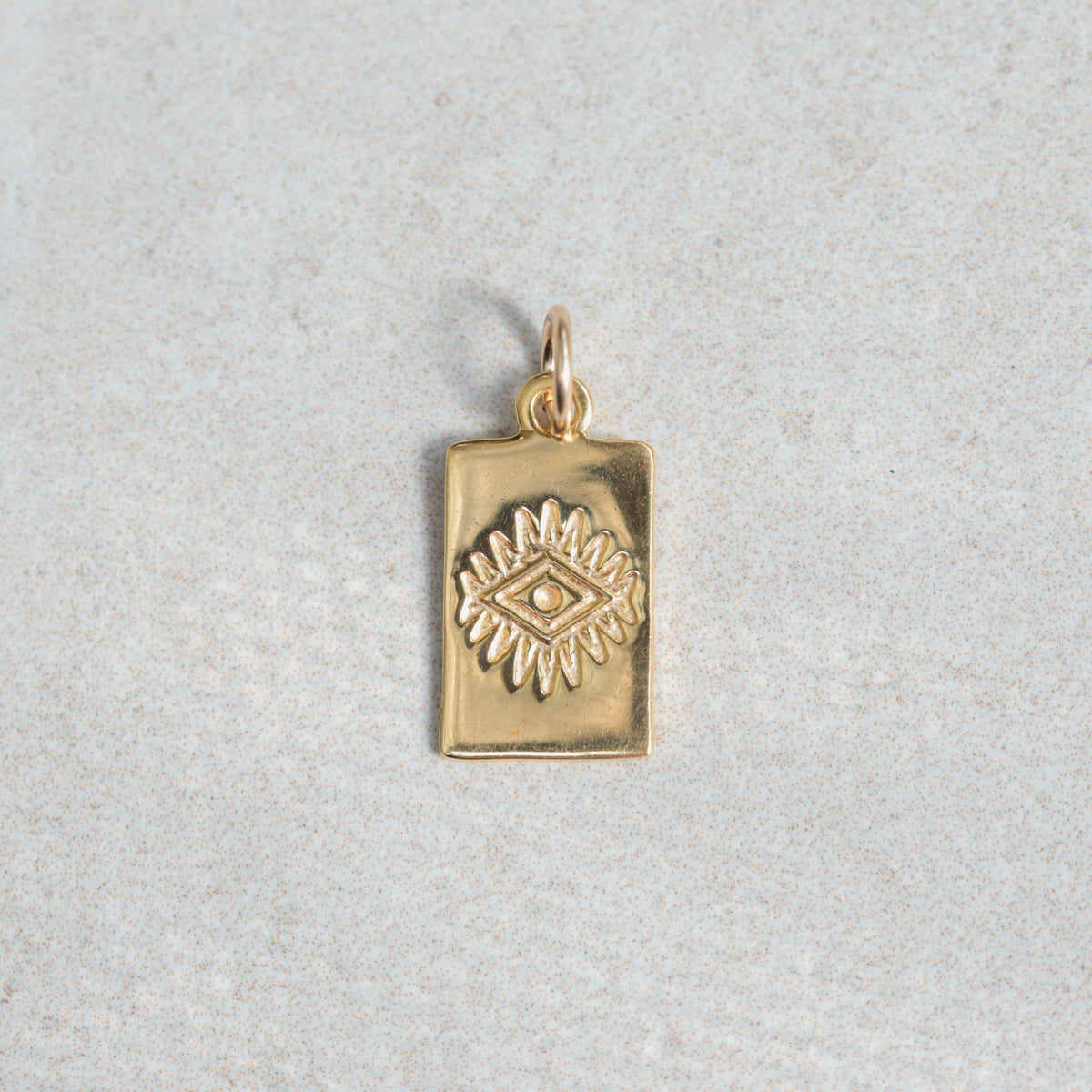 Gold vermeil pendant from Earthly Abundance featuring intricate designs on a delicate chain.