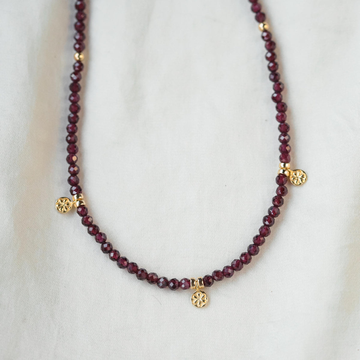 Garnet beaded necklace by Earthly Abundance Jewelry featuring deep red gemstone beads on a delicate string.