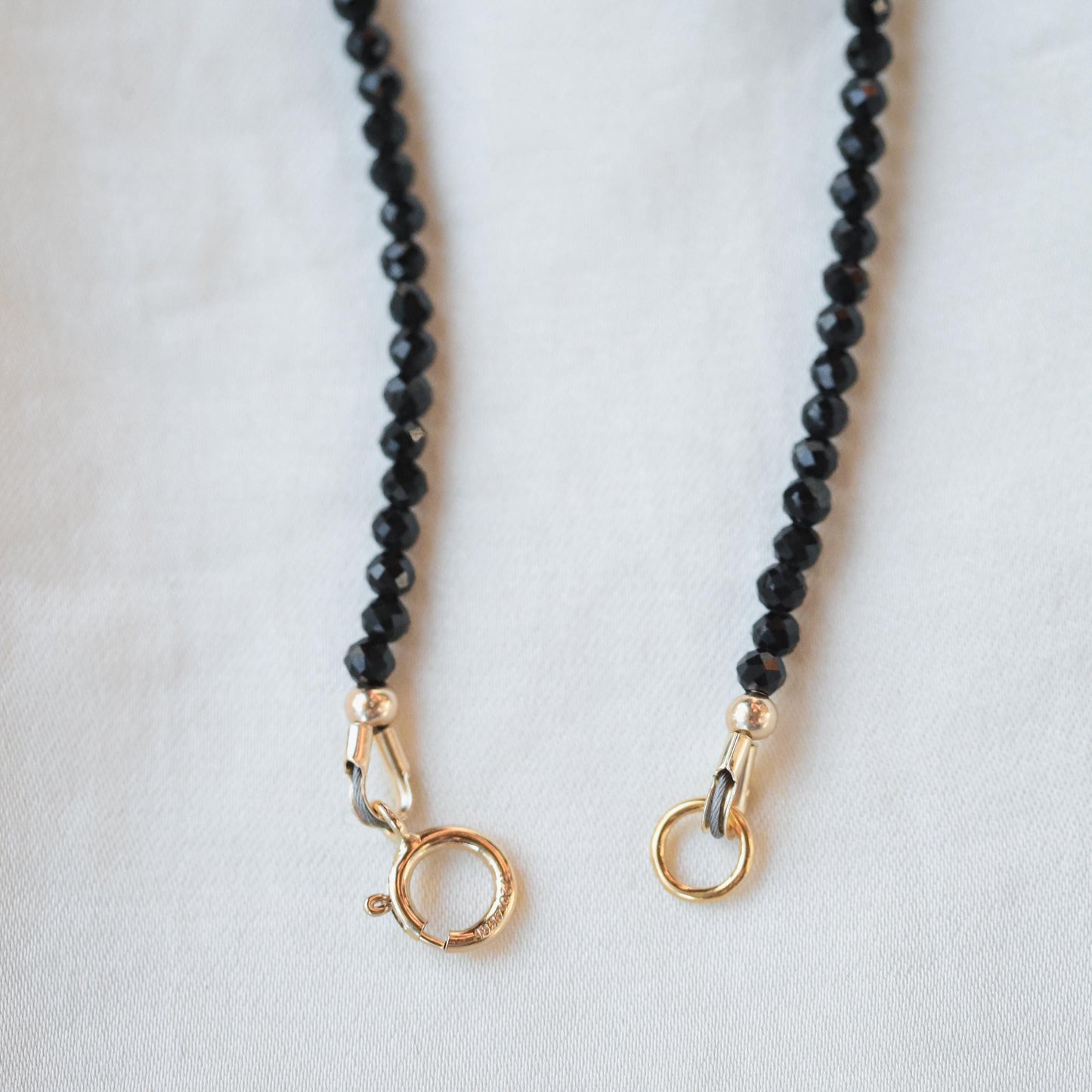 Black tourmaline snake necklace in 14K gold, featuring a detailed snake pendant, from Earthly Abundance.
