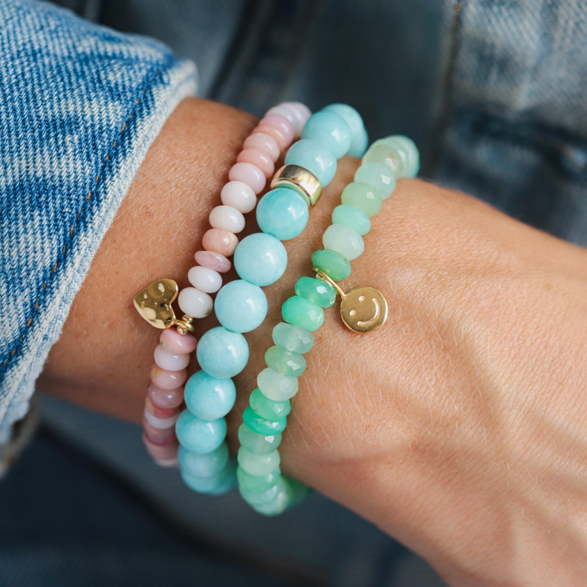 Chrysoprase Smiley Bracelet by Earthly Abundance featuring green gemstone beads and a smiling charm on a delicate bracelet.