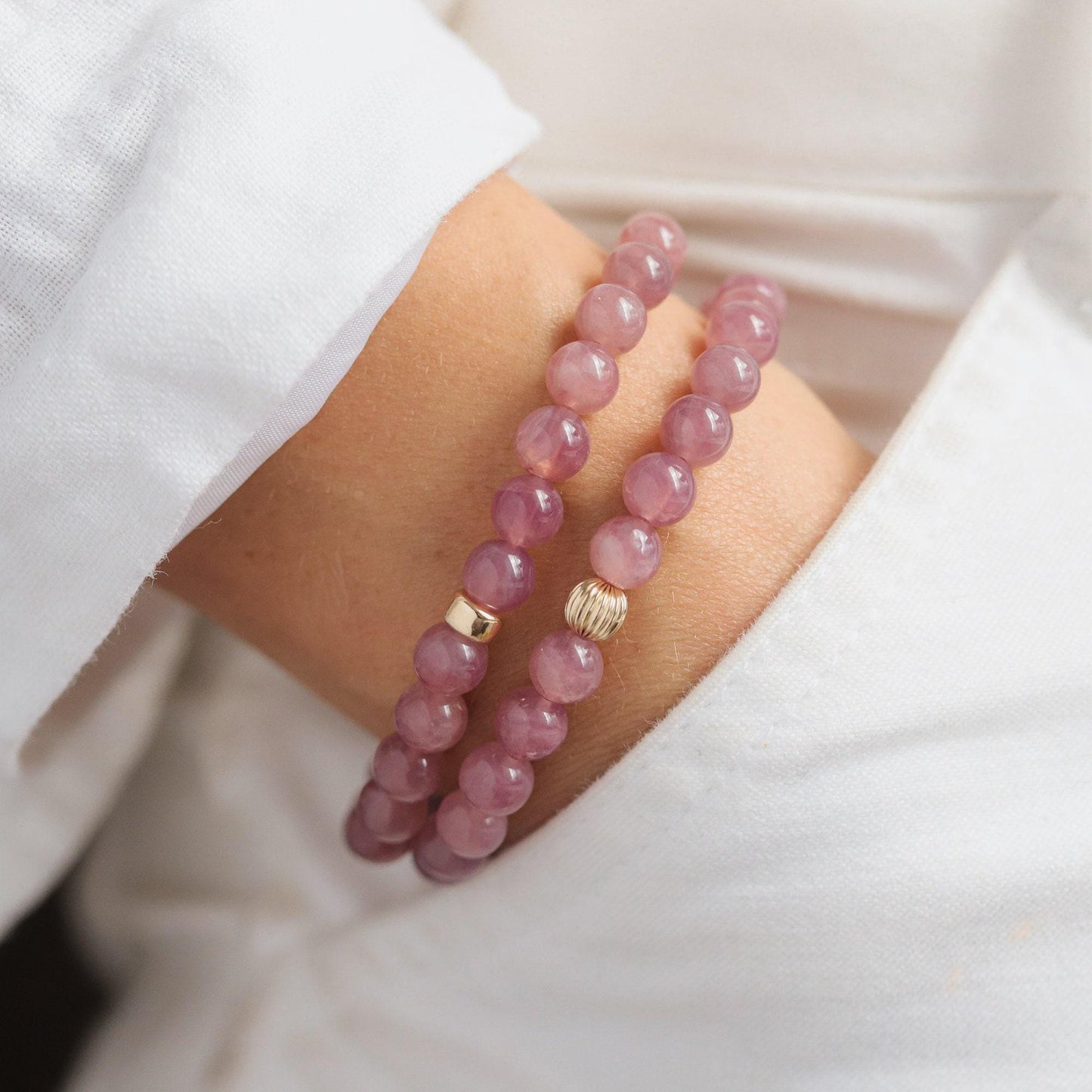 Madagascar Rose Quartz bracelet by Earthly Abundance featuring polished pink quartz beads on an elastic band.