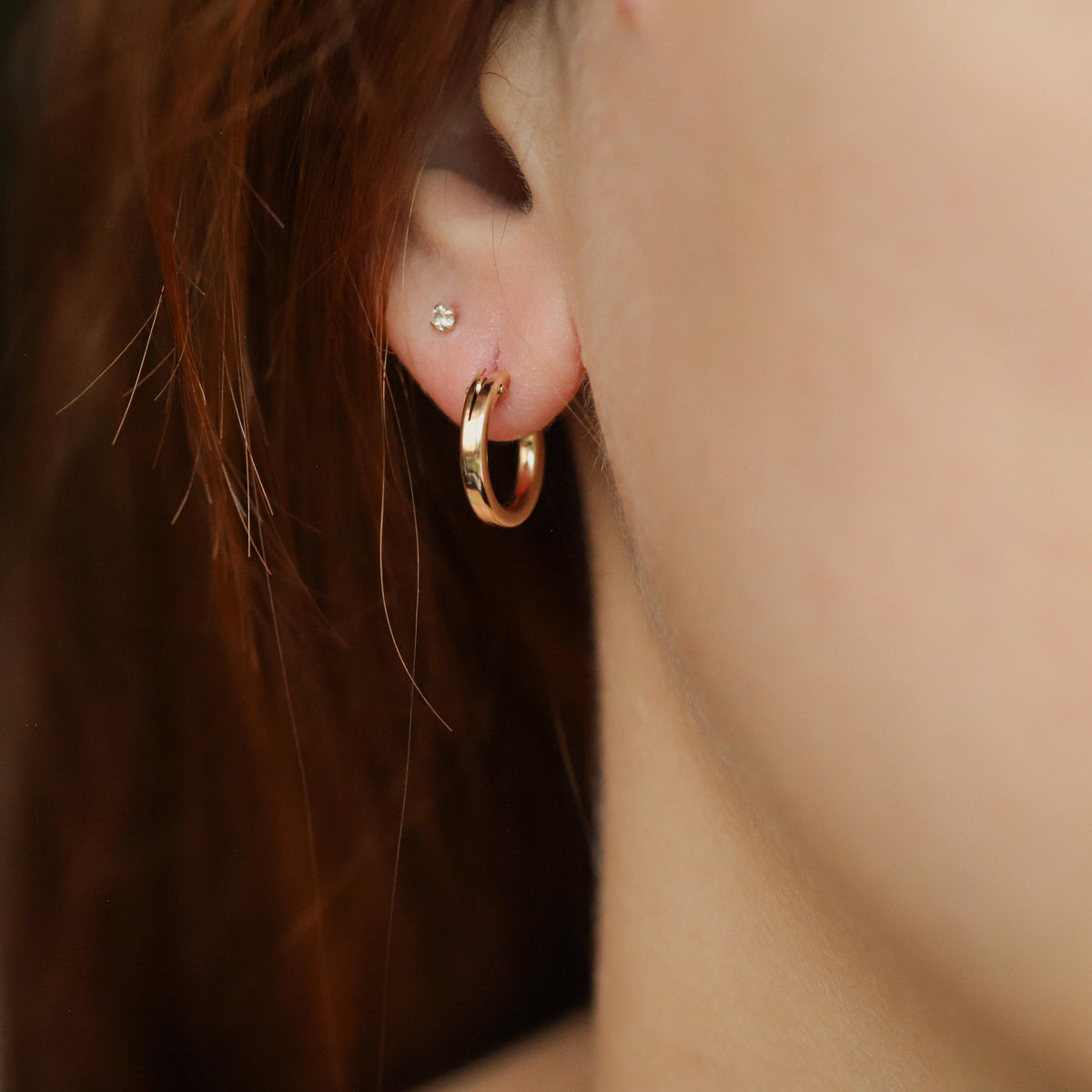14K gold filled Effortless Hoops by Earthly Abundance, showcasing shiny, minimalist hoop earrings on a white background.