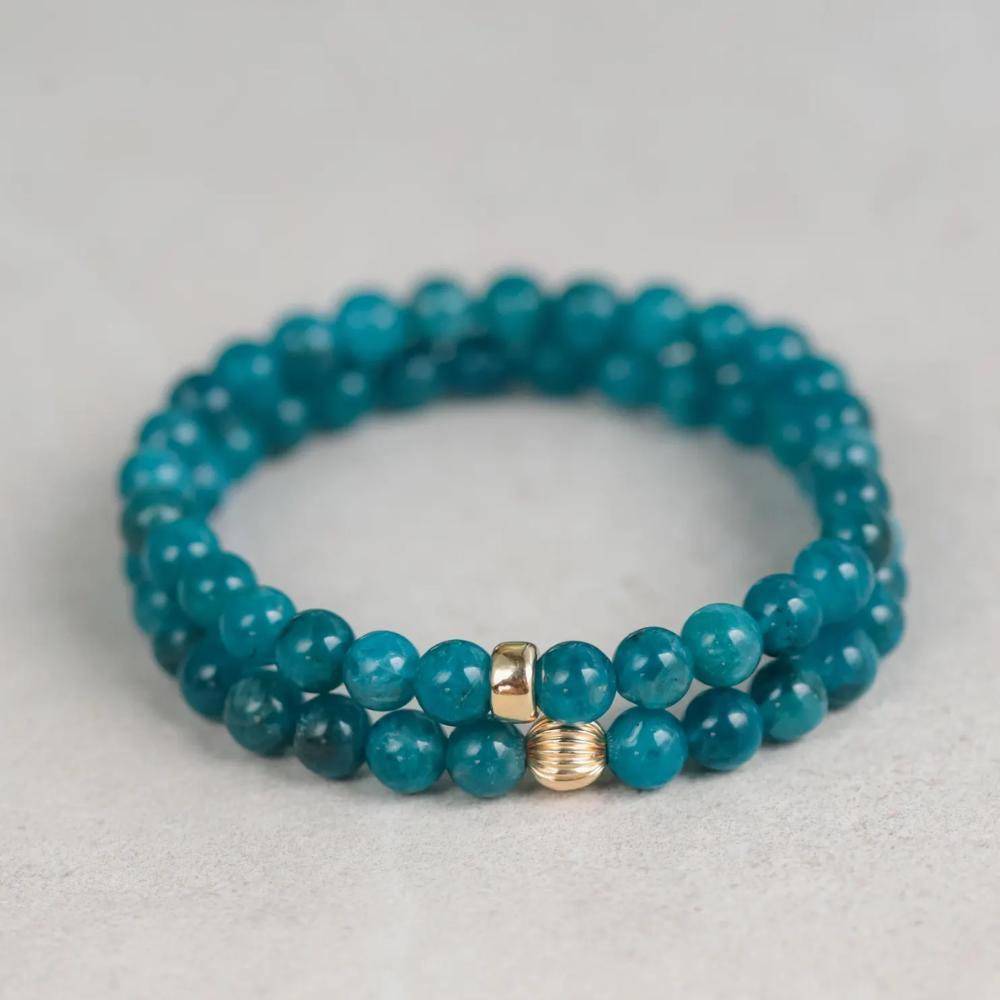 Neon blue Apatite 6mm gemstone bead from Earthly Abundance Jewelry, showcasing its vibrant color and polished smooth surface.