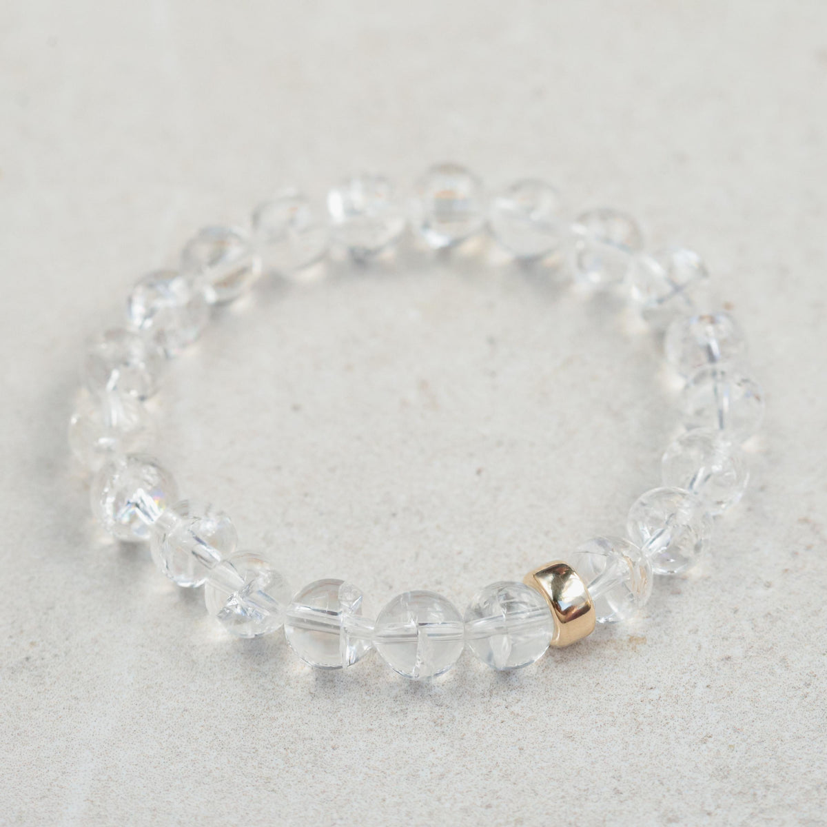 Clear Quartz 8mm gemstone bead from Earthly Abundance, showcasing its transparent, polished surface and natural clarity.