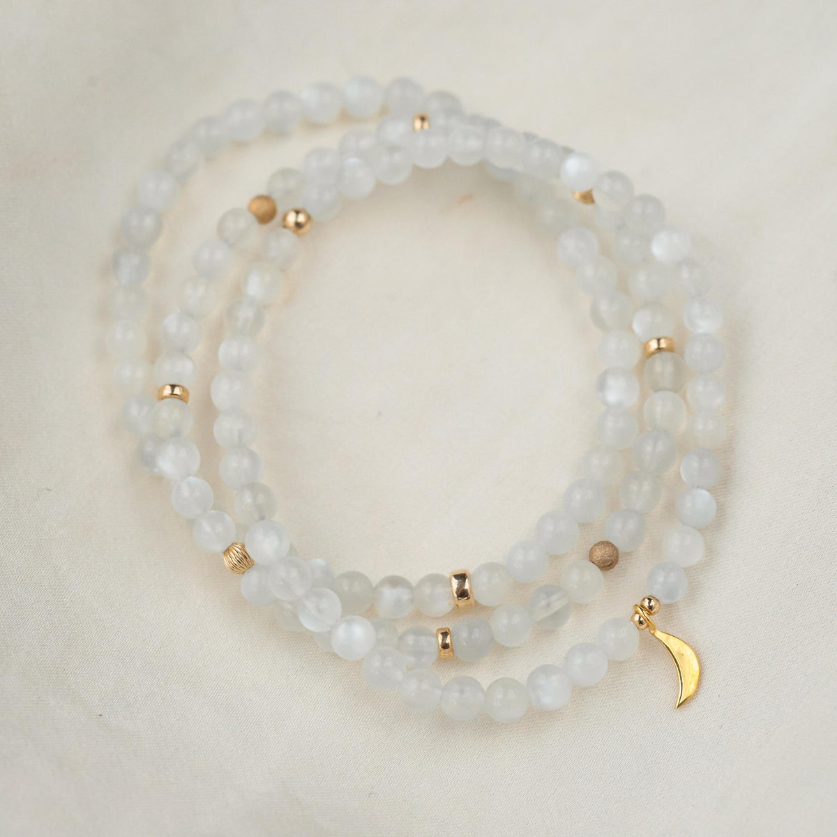 14K moonstone bracelet from Earthly Abundance Jewelry featuring smooth, round moonstone beads on a delicate chain.
