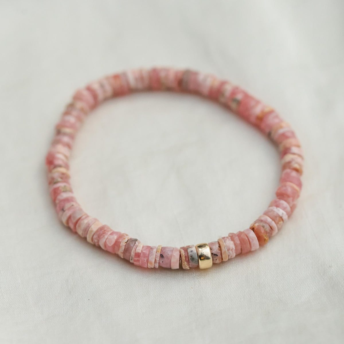 Rhodochrosite Heishi bracelet from Earthly Abundance featuring smooth, round pink gemstone beads on an elastic band.