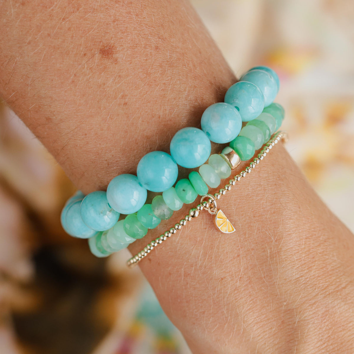 14K lemon charm bracelet by Earthly Abundance featuring a detailed lemon pendant on a delicate chain.
