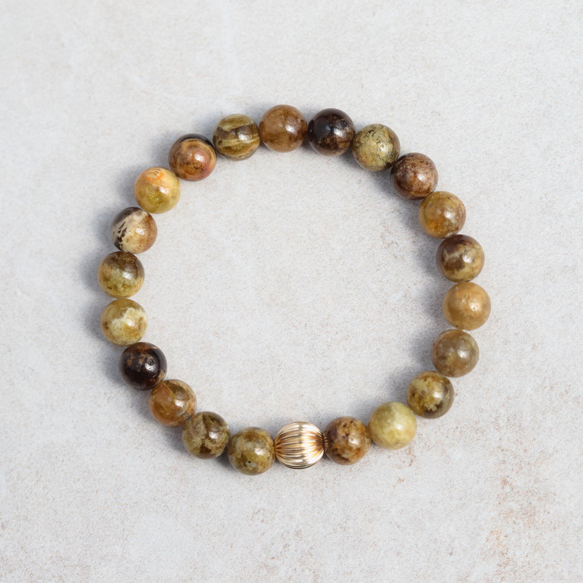 Green garnet bracelet with 14K gold setting featuring polished gemstone beads and elegant clasp design.