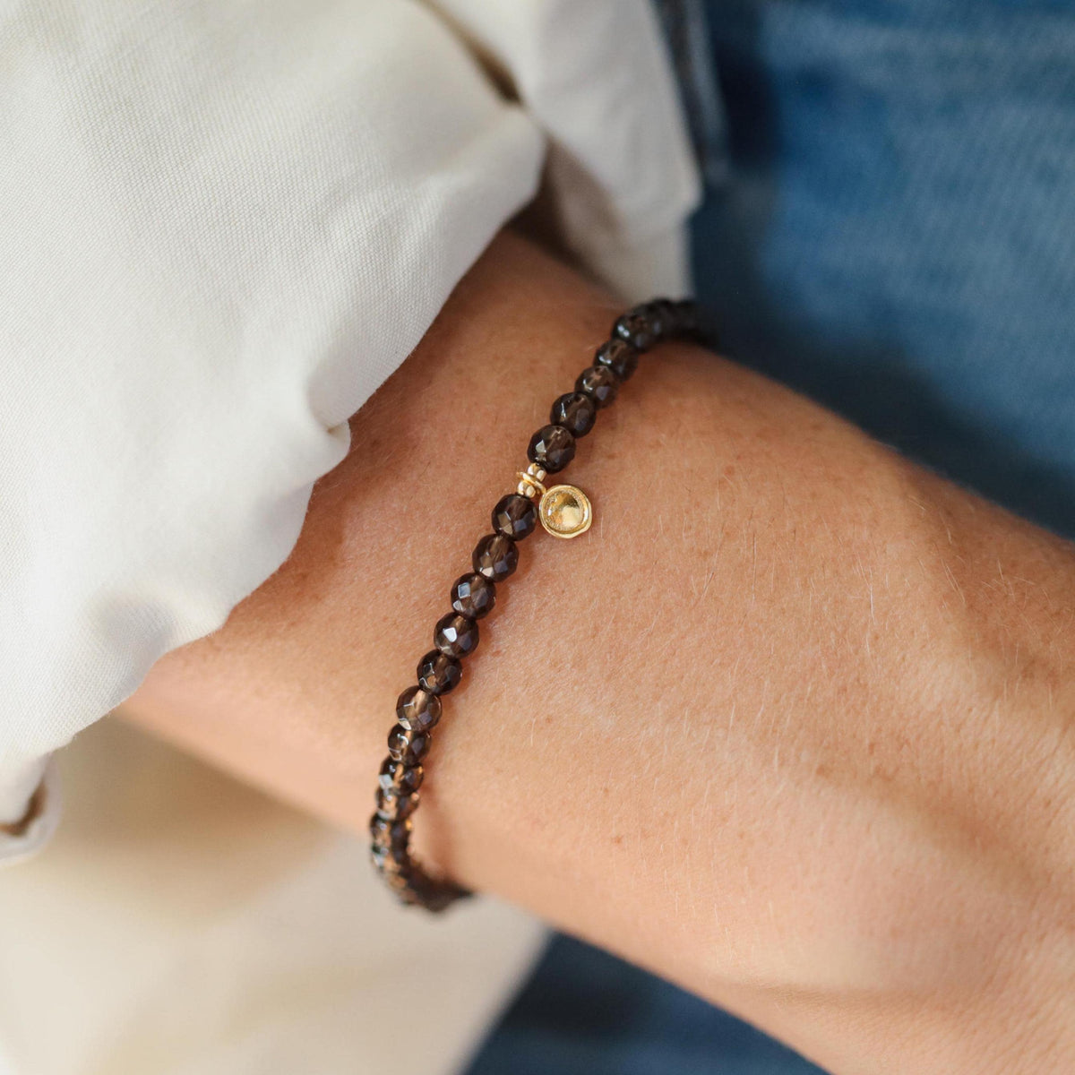 Smoky Quartz bracelet by Earthly Abundance featuring polished beads with natural smoky gray color and elastic stretch band.