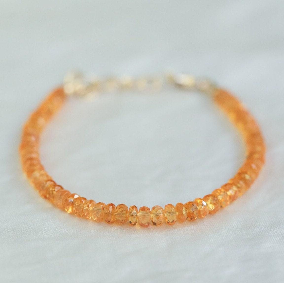 Spessartite Garnet bracelet by Earthly Abundance featuring vibrant orange-red gemstones on a delicate silver chain