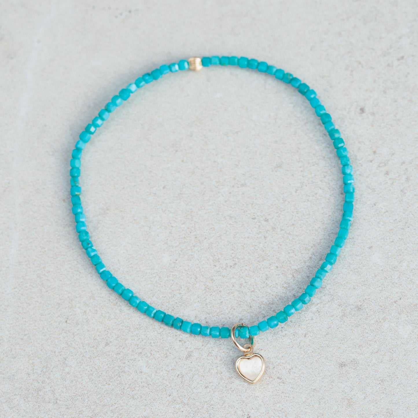 Turquoise cube heart mother of pearl bracelet with 14K gold accents by Earthly Abundance, showcasing its elegant design and craftsmanship.