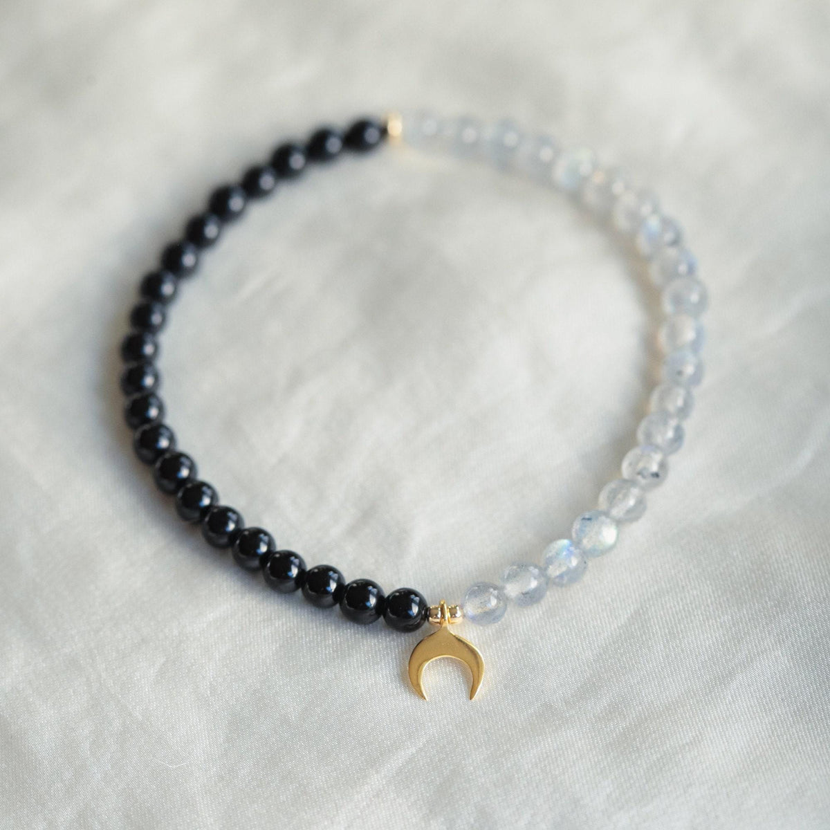 Black Tourmaline and Labradorite moon pendant from Earthly Abundance Jewelry, featuring polished gemstones on a silver setting.
