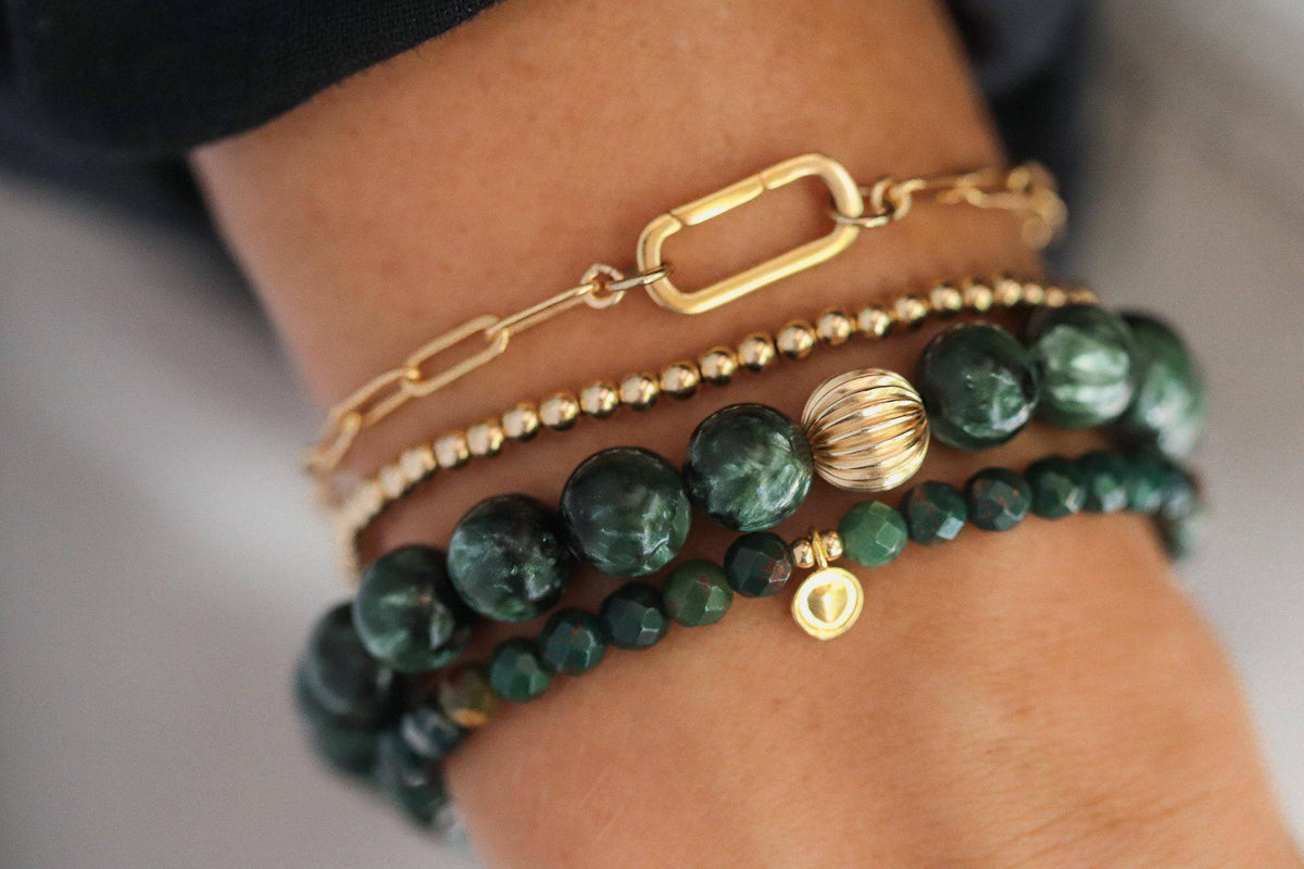 Seraphinite 8mm gemstone beads with 14K gold accents from Earthly Abundance Jewelry, showcasing polished green and silver-toned stones.