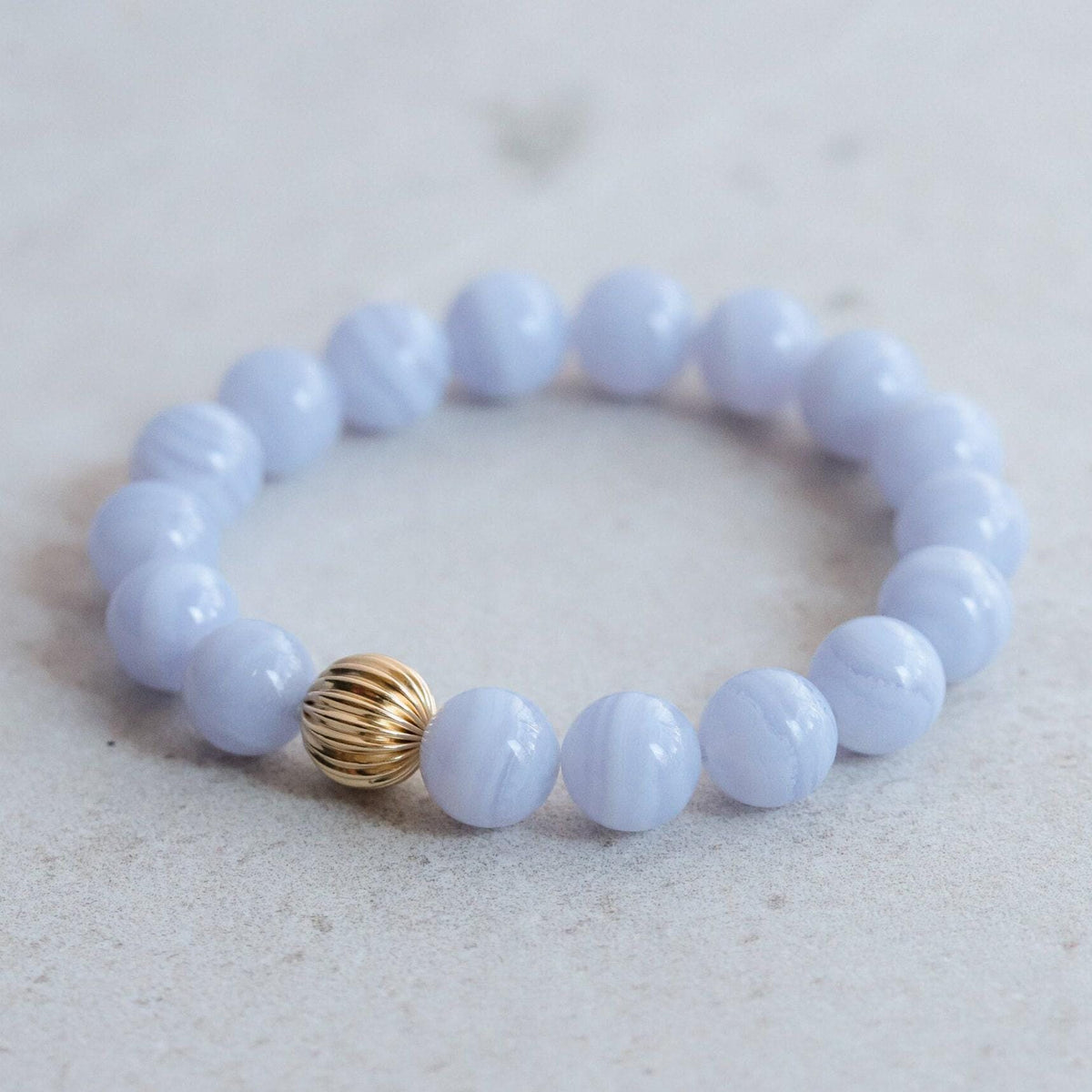 Blue lace agate 10mm gemstone beads from Earthly Abundance, showcasing smooth, polished blue and white banded stones.