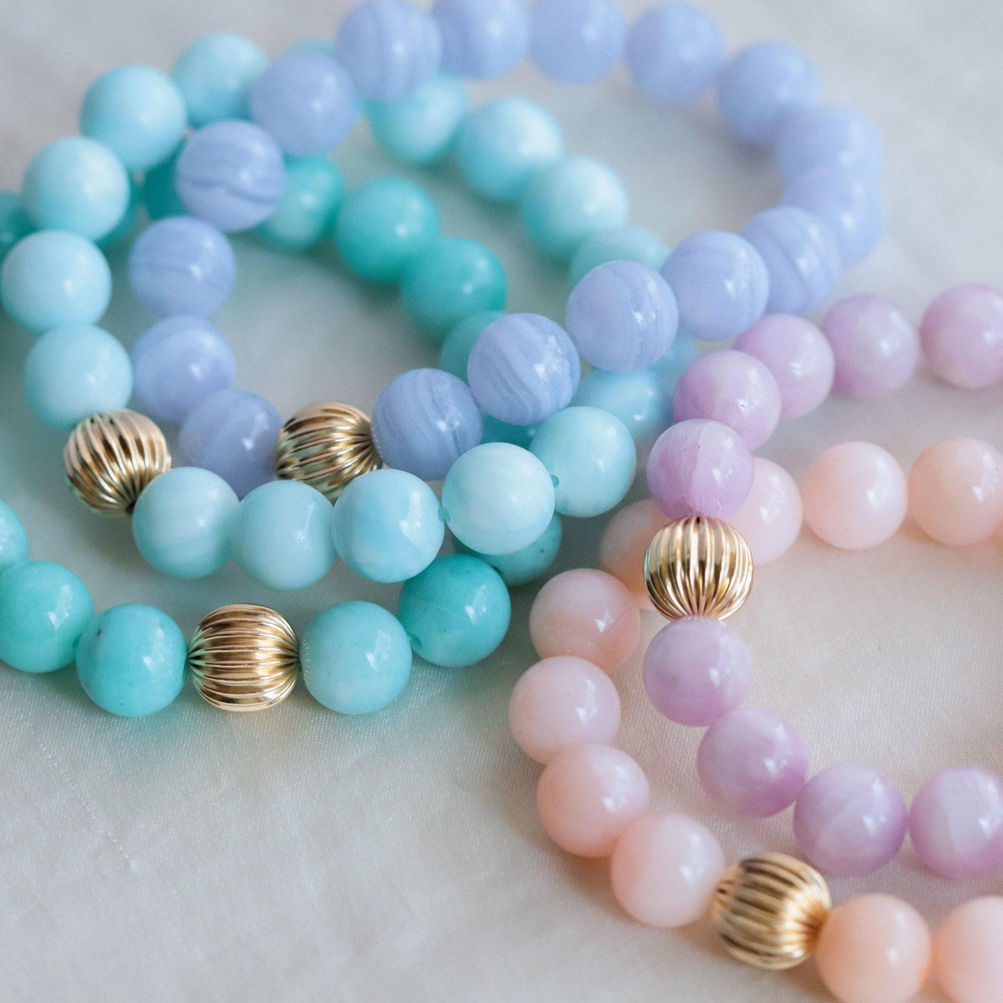 Blue lace agate 10mm gemstone beads from Earthly Abundance, showcasing smooth, polished blue and white patterned stones.