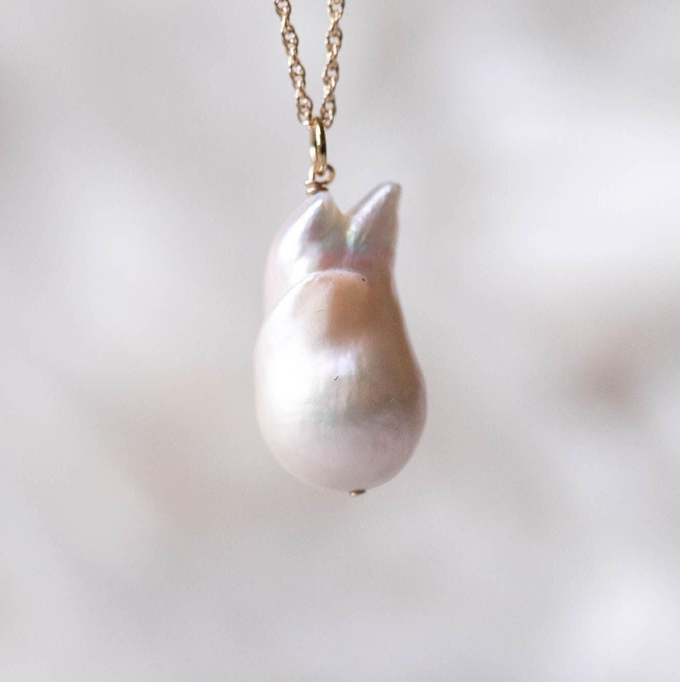 Elegant Baroque Pearl necklace by Earthly Abundance Jewelry featuring irregular-shaped lustrous pearls on a delicate chain.