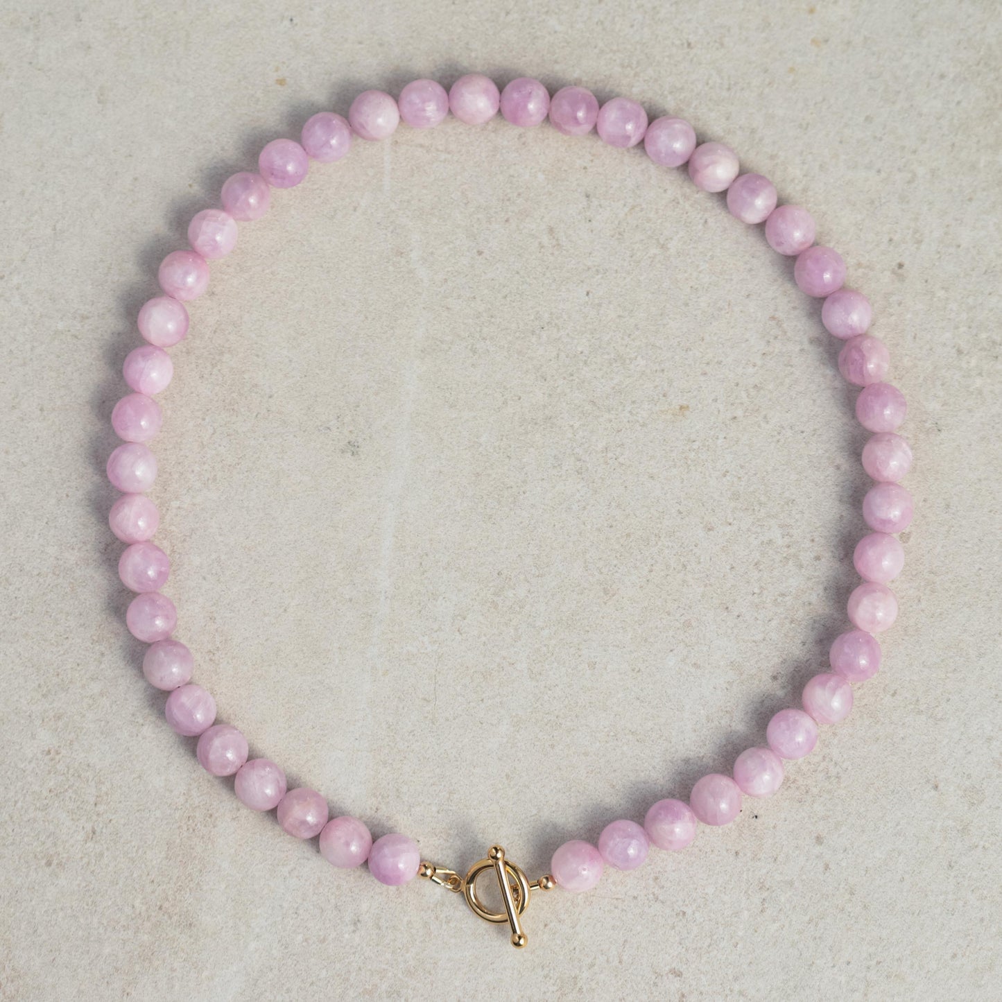 Kunzite beaded toggle necklace by Earthly Abundance featuring pink-purple stones and a silver toggle clasp.