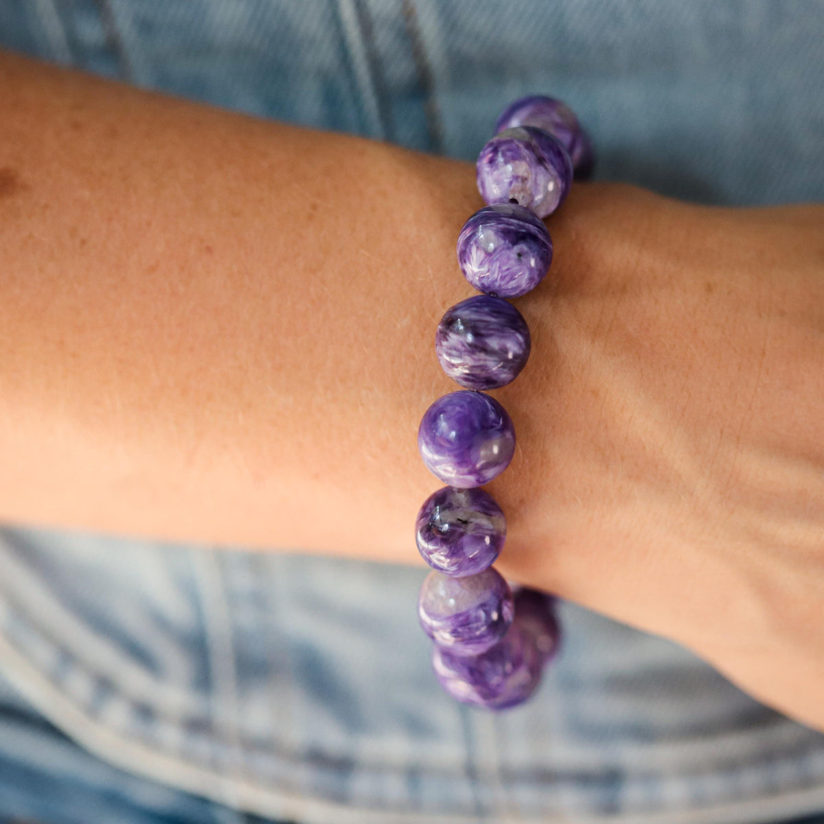 AAAA+ grade 12mm Charoite gemstone bead from Earthly Abundance, showcasing vibrant purple color and polished surface.