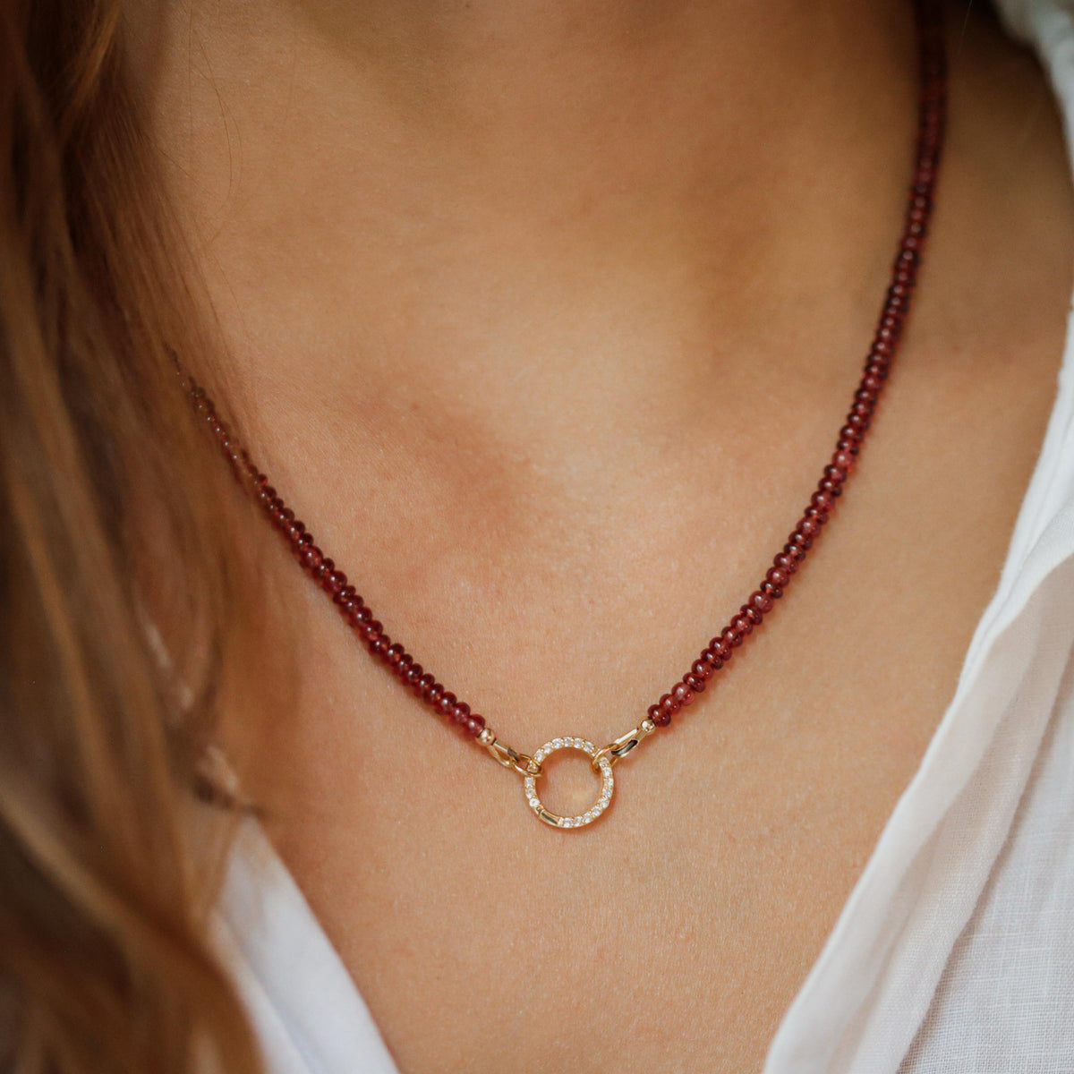 Garnet and white topaz necklace from Earthly Abundance featuring a silver chain with a central gemstone pendant.
