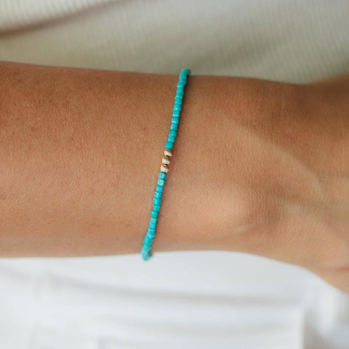 Turquoise beaded bracelet by Earthly Abundance featuring vibrant blue beads and a simple elastic design.