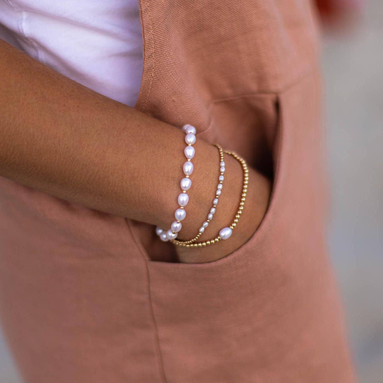 Freshwater pearl from Earthly Abundance Jewelry with smooth, lustrous surface and classic round shape on a neutral background.