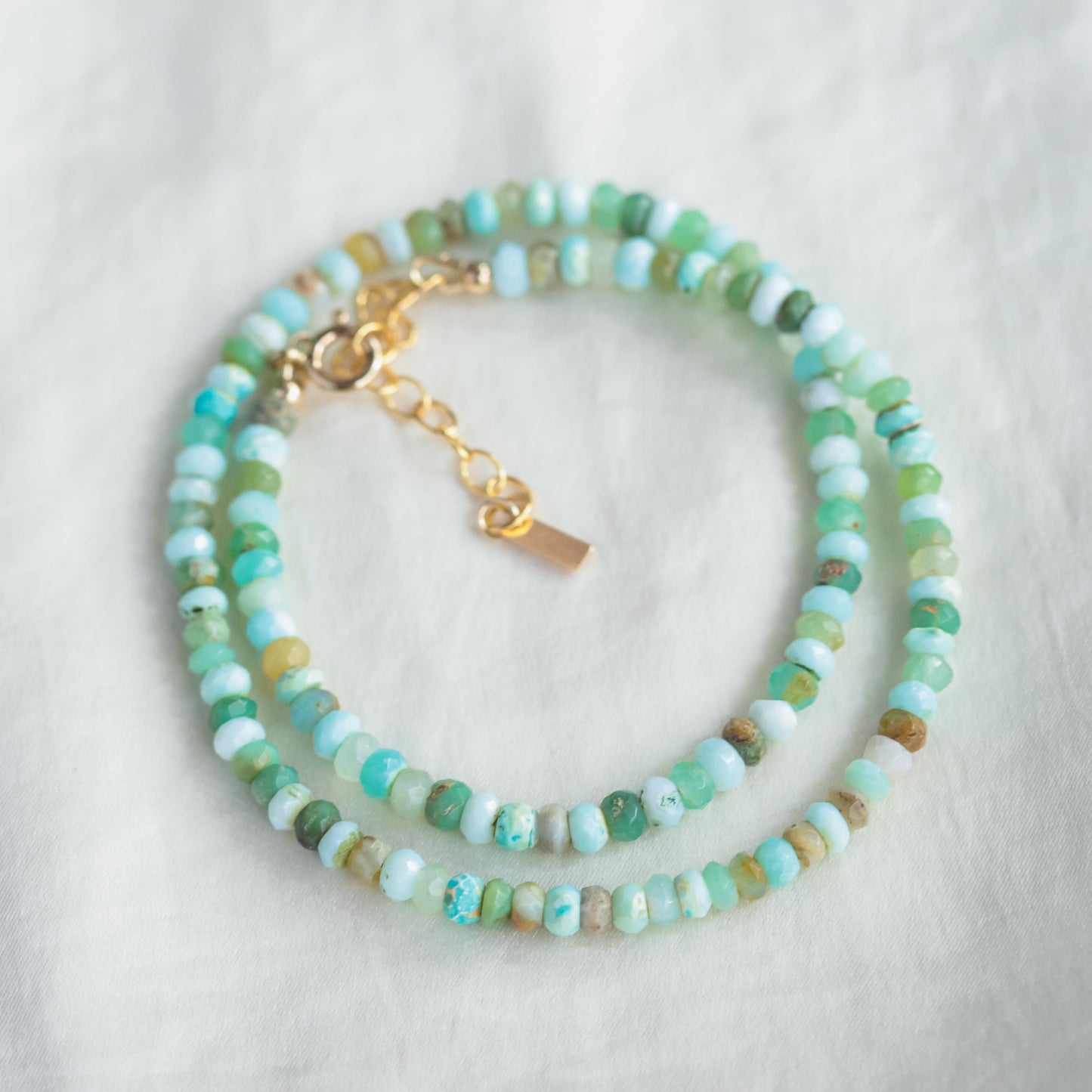 Peruvian opal necklace with 14K gold-filled chain, featuring vibrant, polished opal gemstones on a delicate jewelry piece.