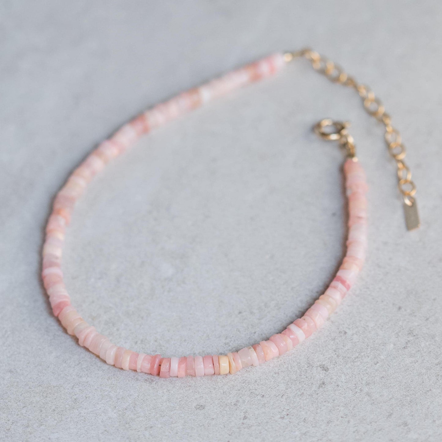 Pink opal heishi anklet from Earthly Abundance featuring small round pink gemstone beads on a delicate string.