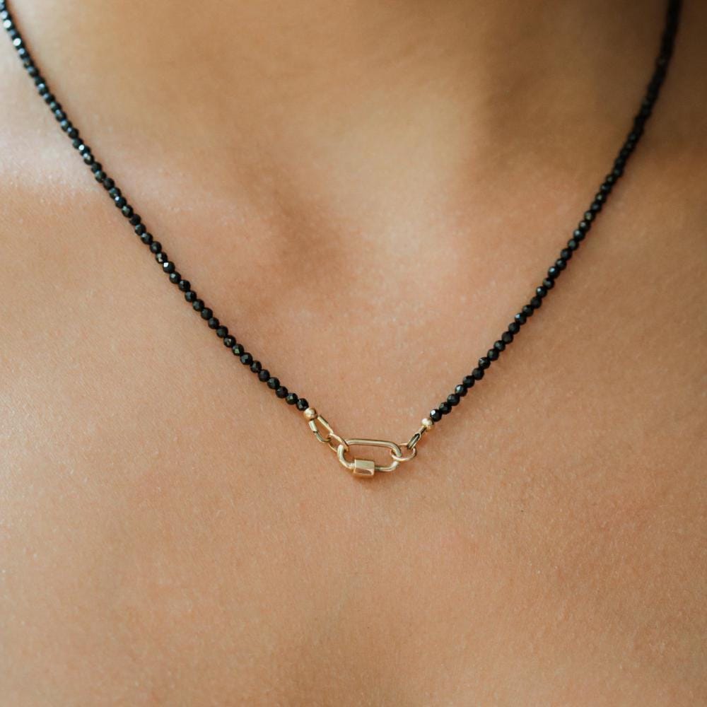 Lore Black Tourmaline Necklace in 14K gold from Earthly Abundance, featuring a polished black tourmaline pendant.