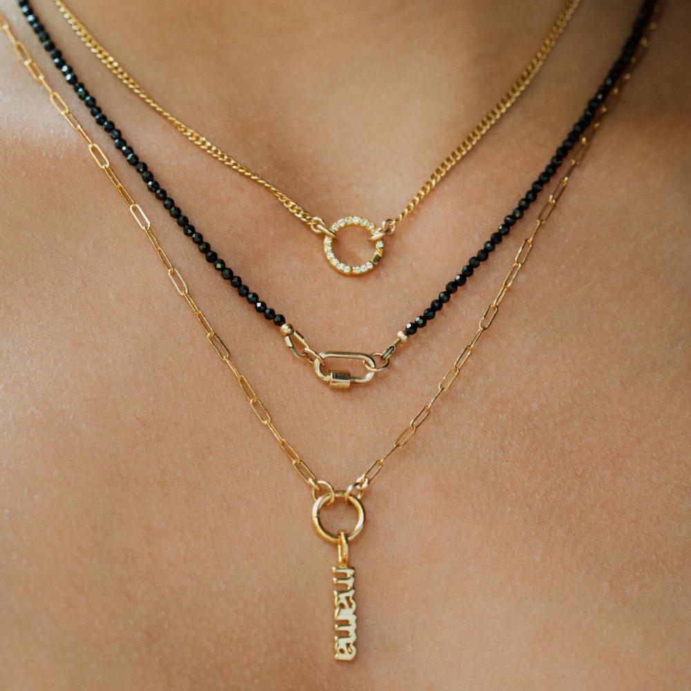 Lore Black Tourmaline Necklace with 14K gold chain from Earthly Abundance, featuring a polished black tourmaline pendant.