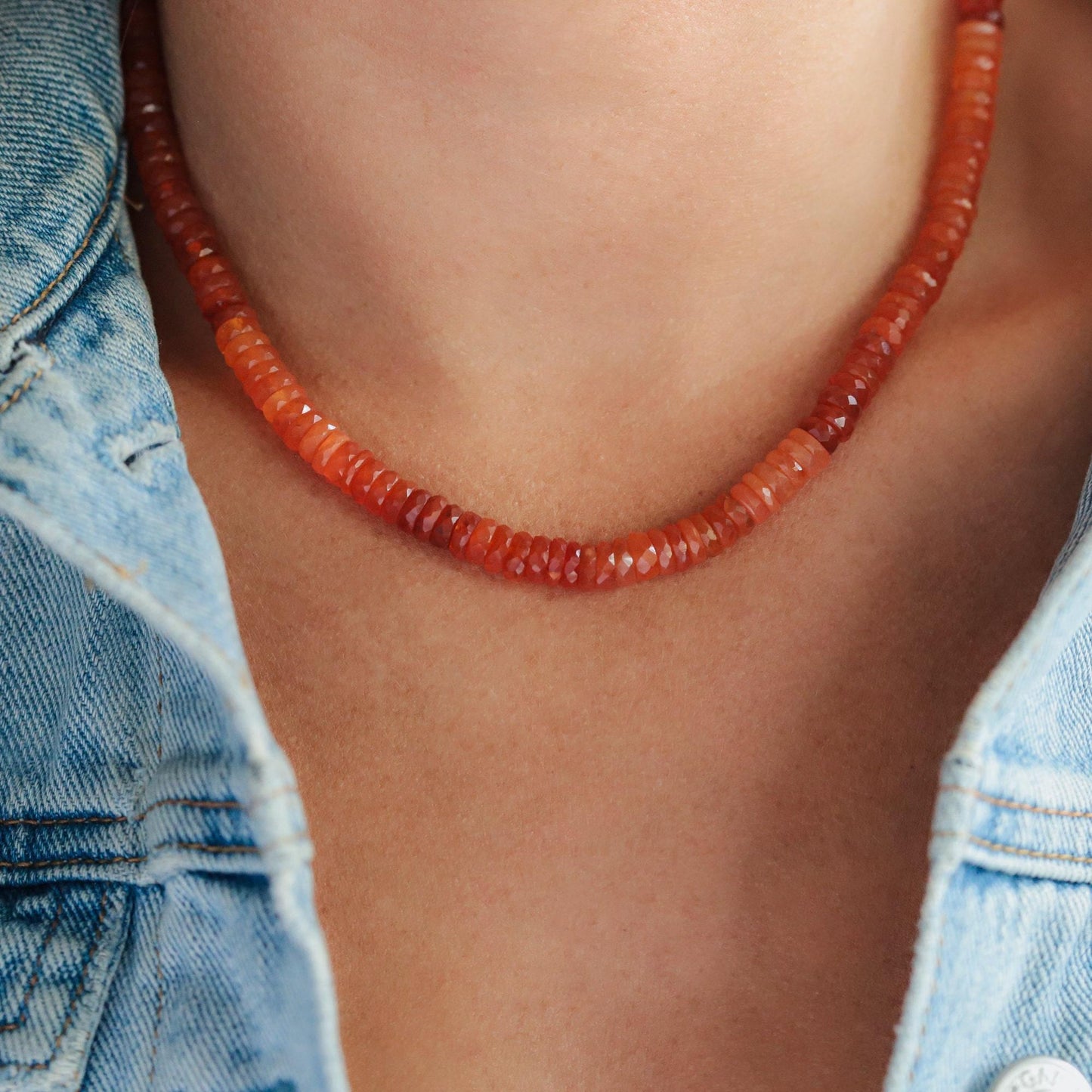 Carnelian heishi necklace by Earthly Abundance featuring round orange stone beads on a string.