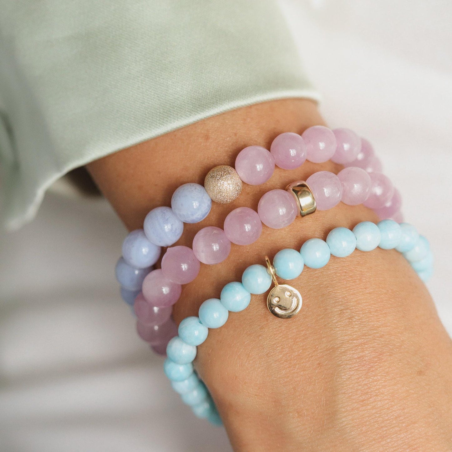 Blue Lace Agate and Kunzite gemstone jewelry from Earthly Abundance with vibrant blue and pink hues, showcasing intricate natural stone patterns.