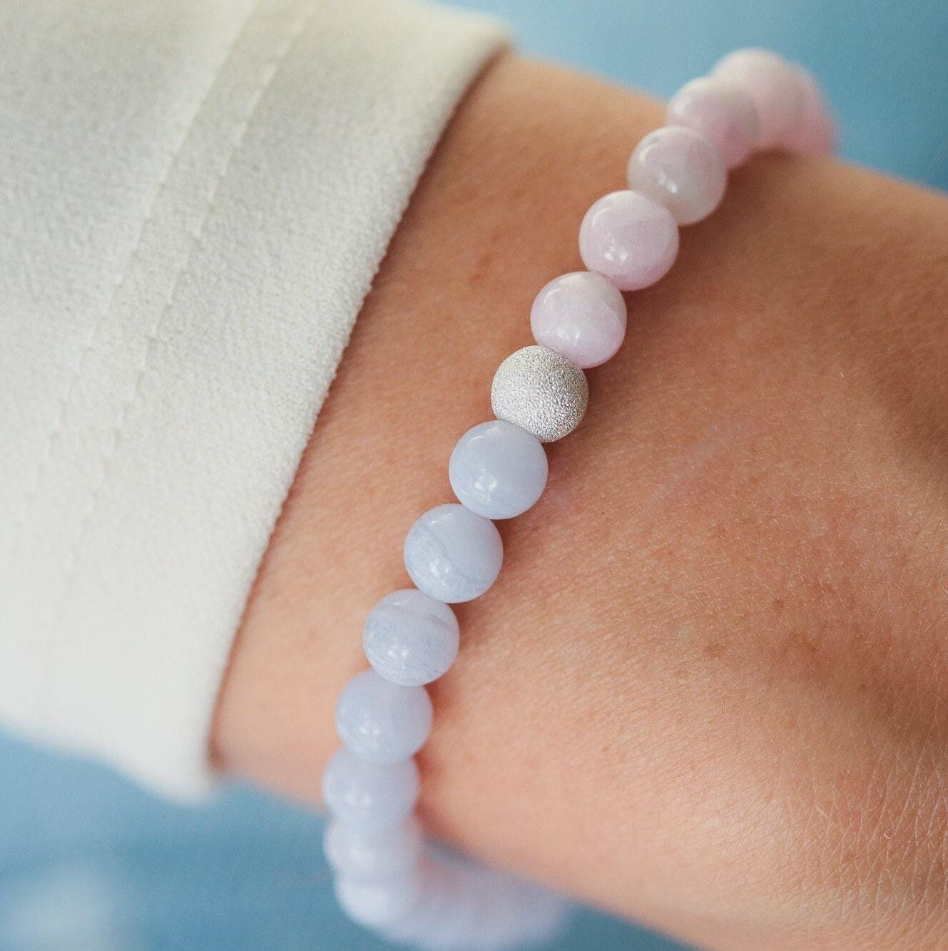 Blue Lace Agate and Kunzite gemstone jewelry by Earthly Abundance featuring polished blue and pink stones in a delicate design.