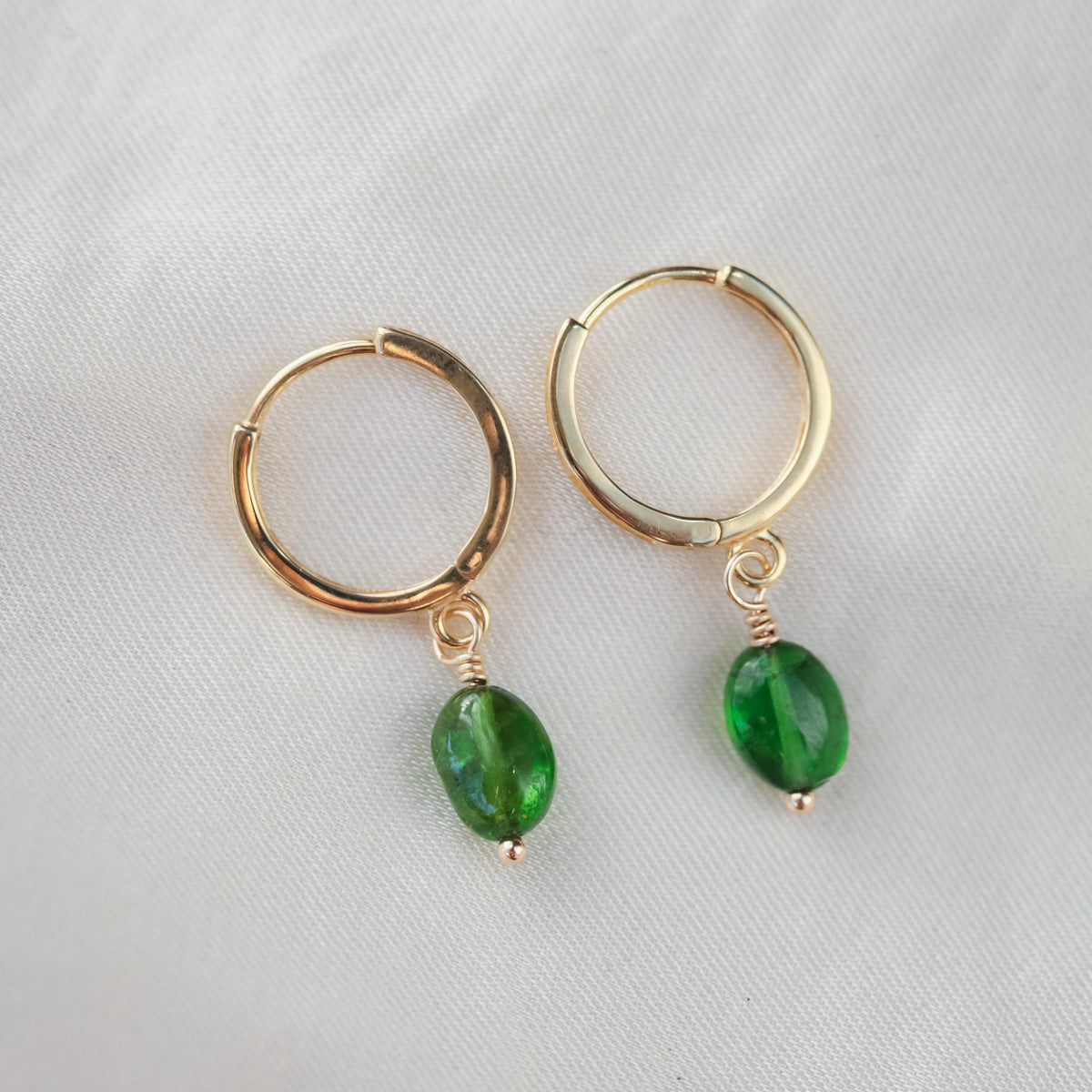Chrome diopside hoops earrings in 14K gold with a sleek, polished finish, featuring vibrant green gemstones.