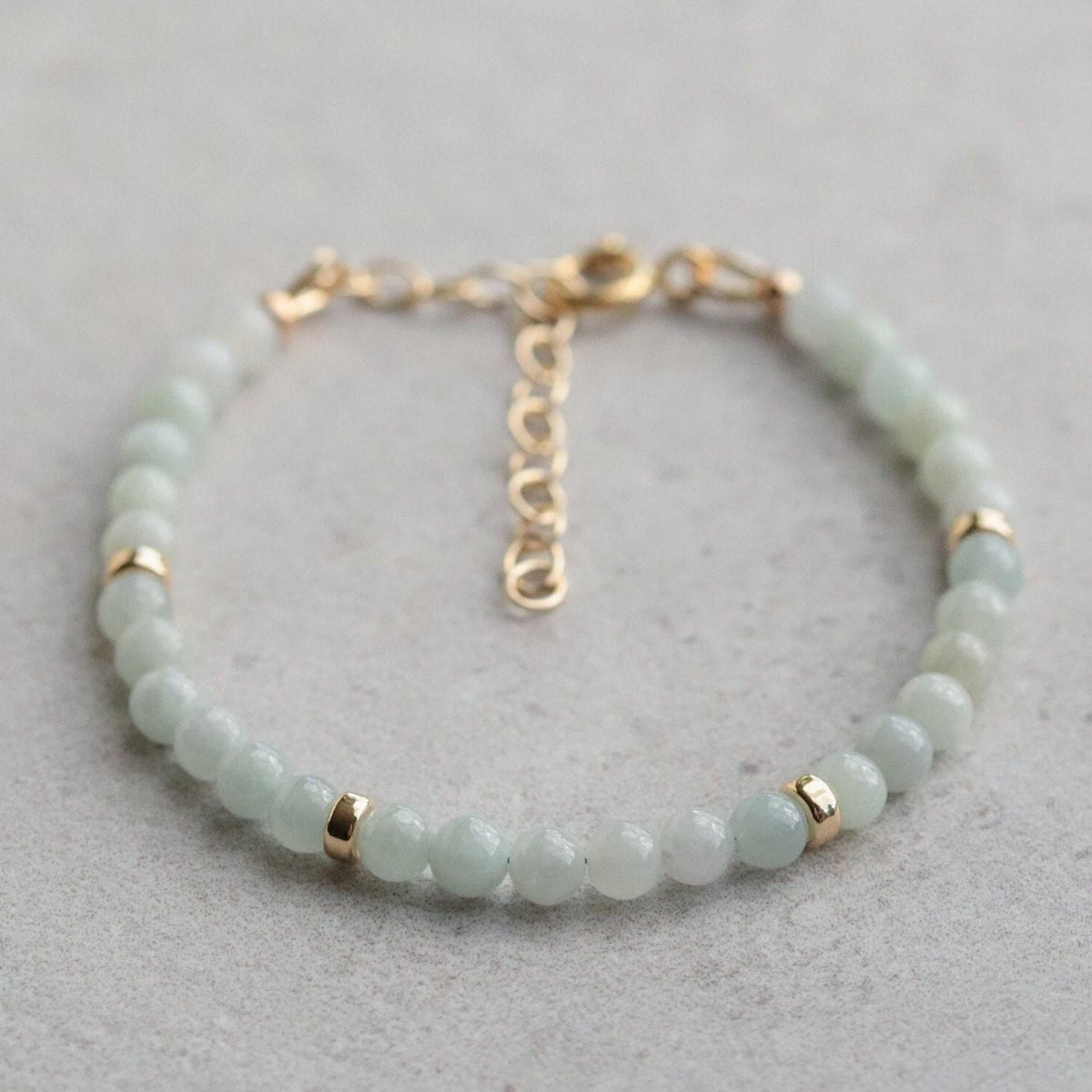 Earthly Abundance Jadeite Bracelet with 4mm beads featuring smooth, polished jadeite stones on a delicate elastic band.
