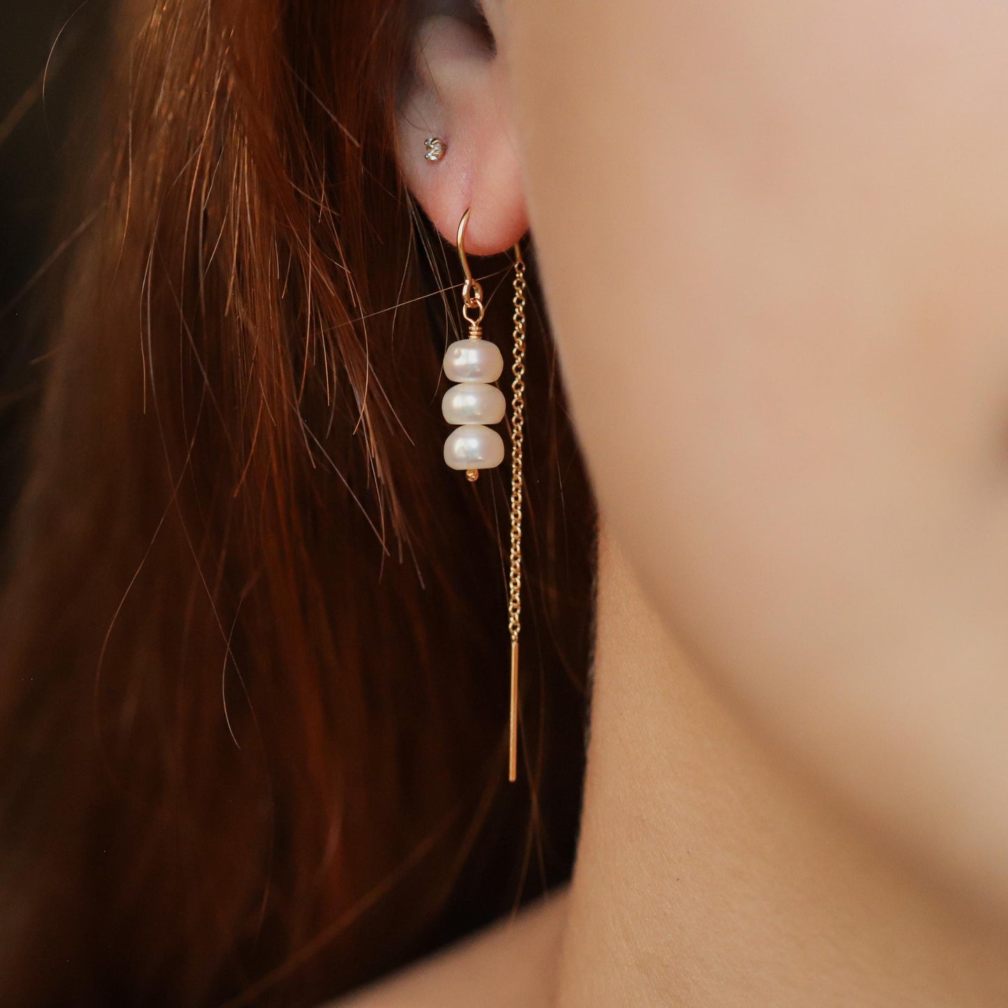 Elegant freshwater pearl threader earrings by Earthly Abundance featuring delicate pearl strands for a sophisticated look.