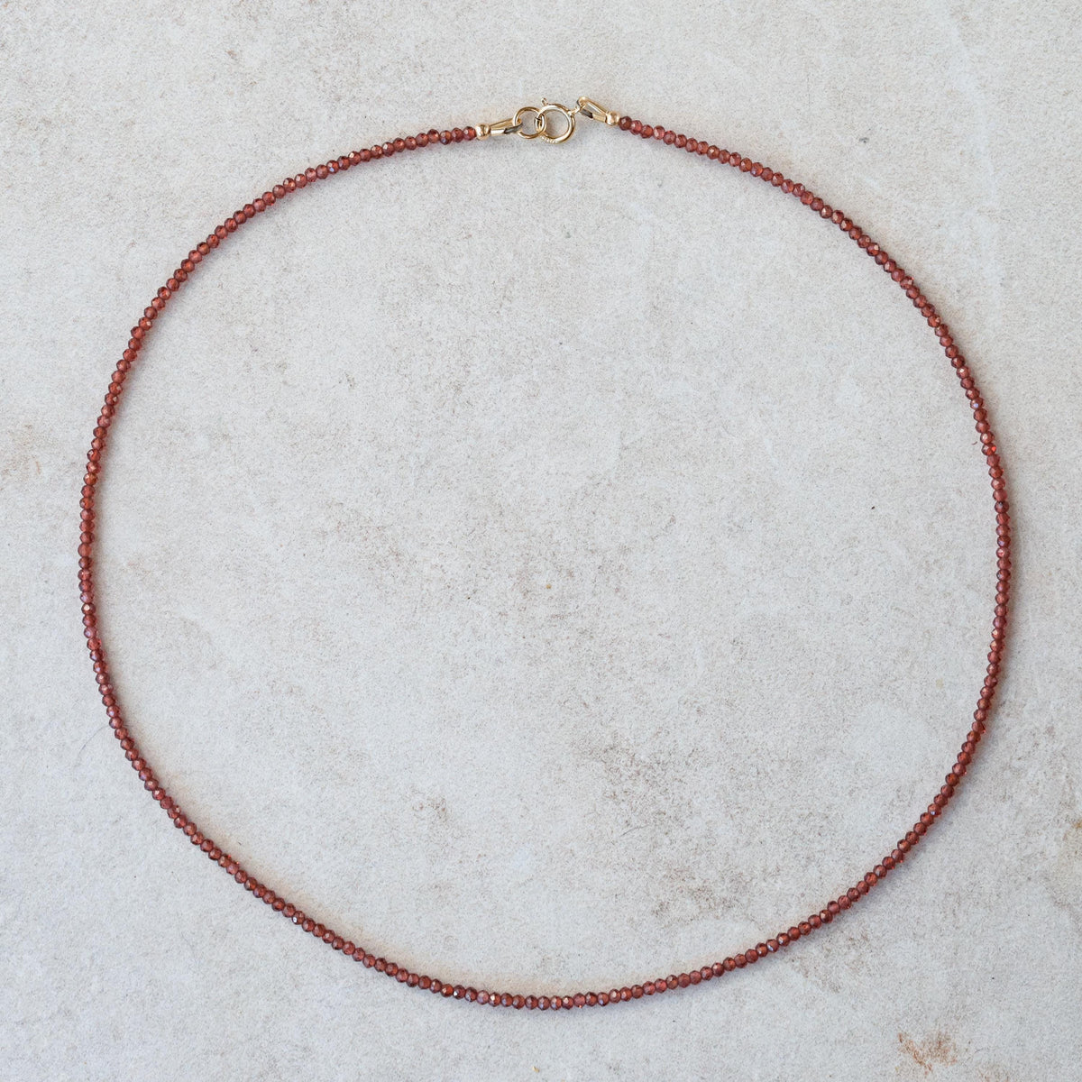 Earthly Abundance garnet 2mm beaded necklace featuring deep red gemstones on a delicate chain.