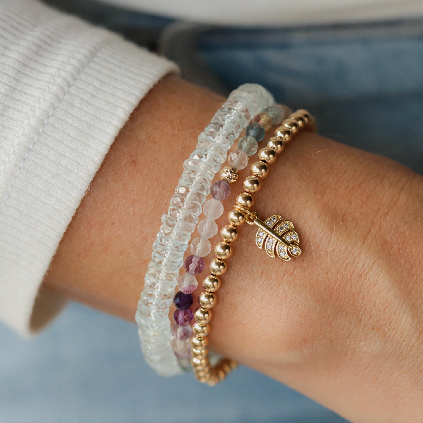 Colorful Rainbow Fluorite bracelet with polished gemstones from Earthly Abundance displayed in a close-up shot.