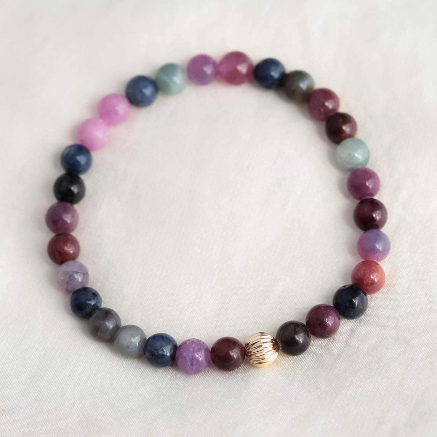 Elegant Ruby and Sapphire bracelet featuring 14K gold from Earthly Abundance, showcasing vibrant gemstones and fine craftsmanship.