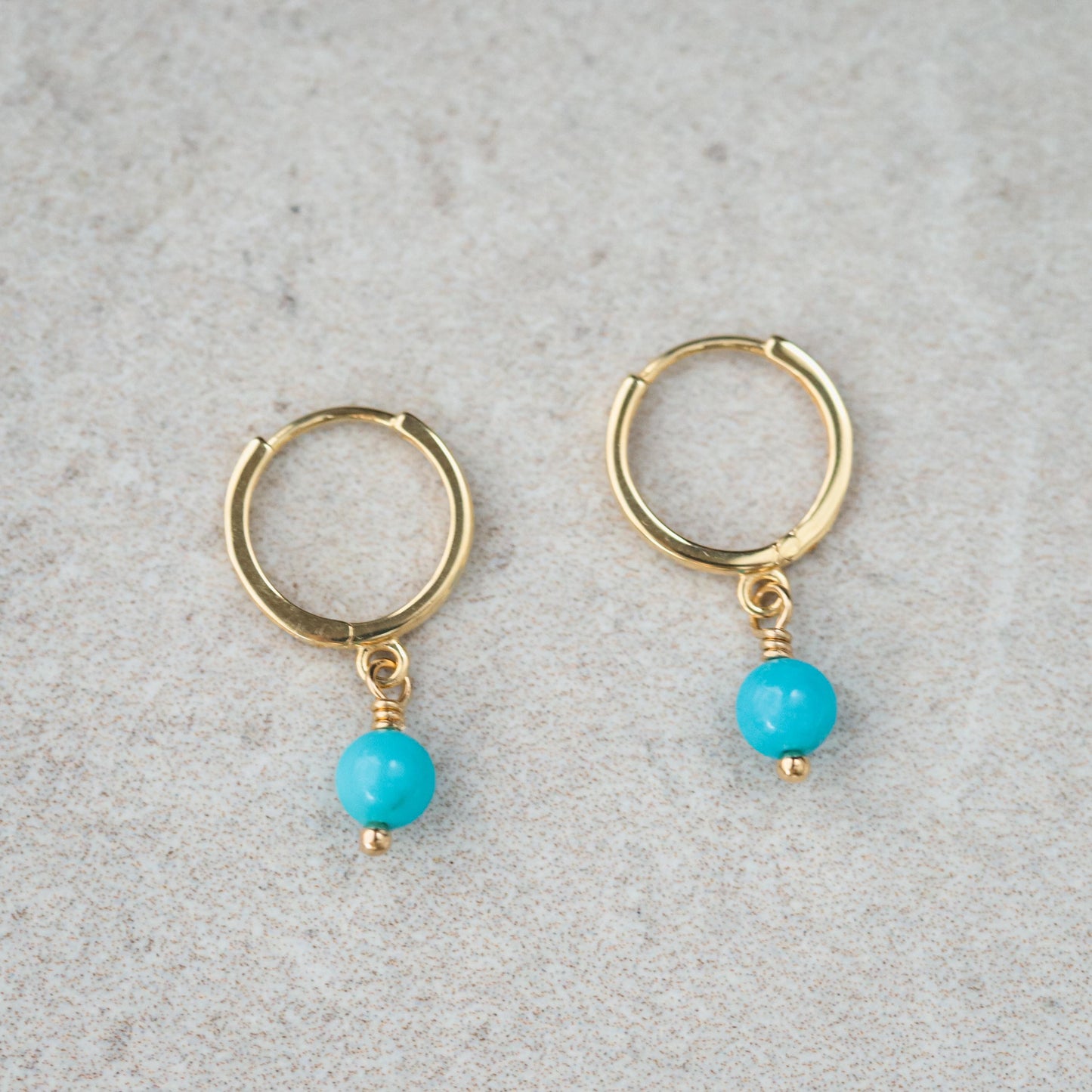 Sleeping Beauty turquoise hoops earrings in 14K gold by Earthly Abundance, featuring vibrant turquoise stones and classic hoop design.