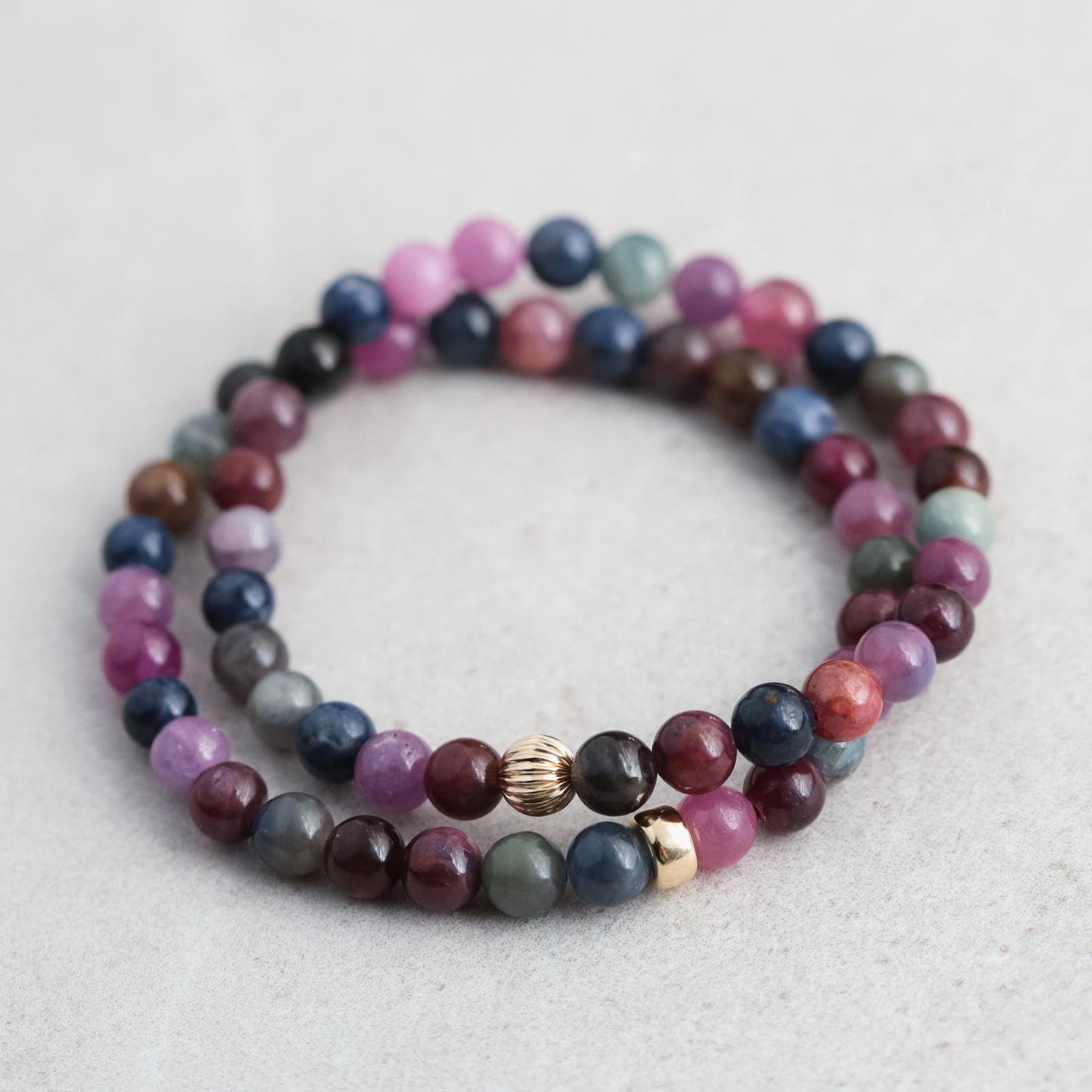 14K Ruby and Sapphire bracelet with alternating red and blue gemstones on a delicate gold chain.