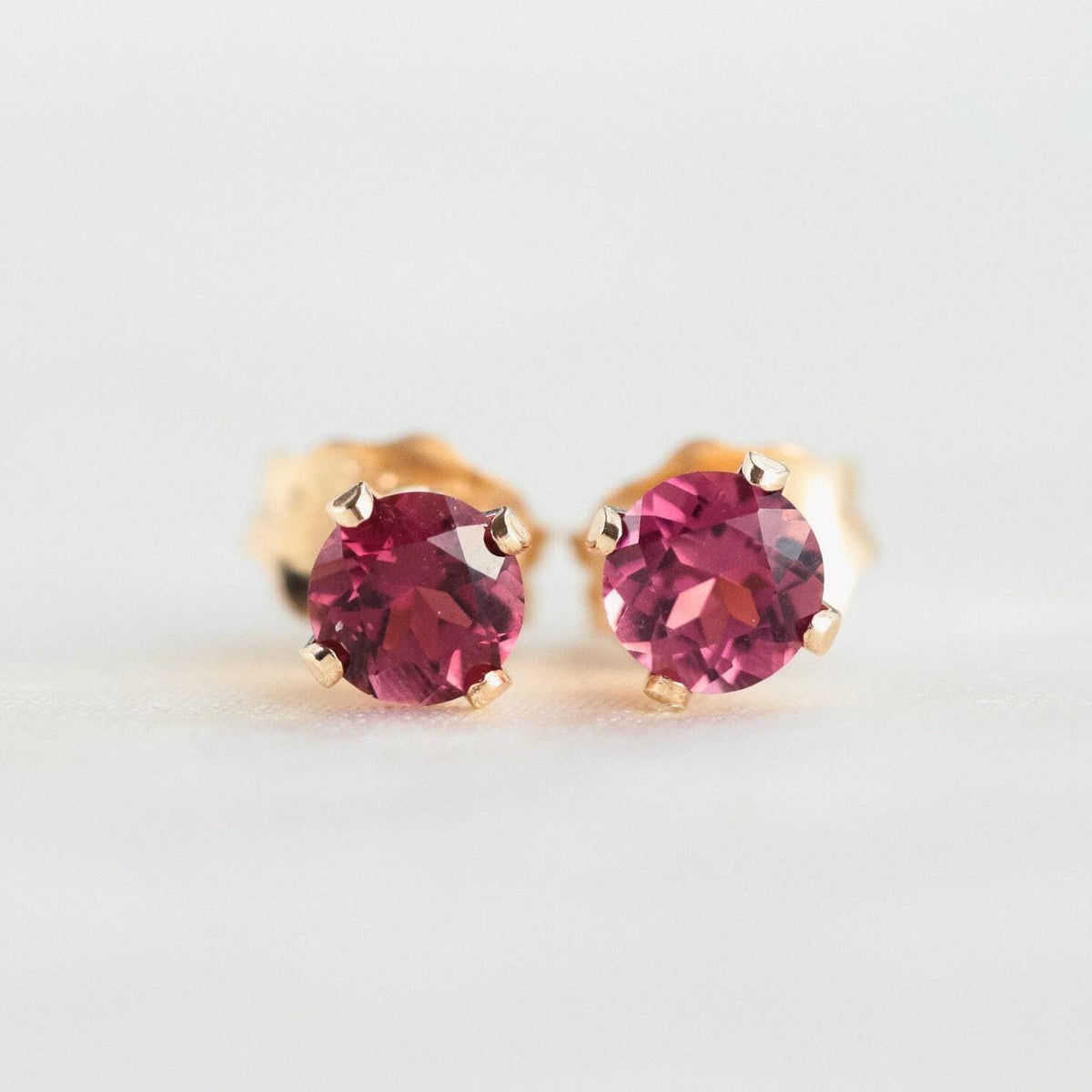 Pink tourmaline stud earring by Earthly Abundance featuring a sparkling pink gemstone set in a simple metal stud.