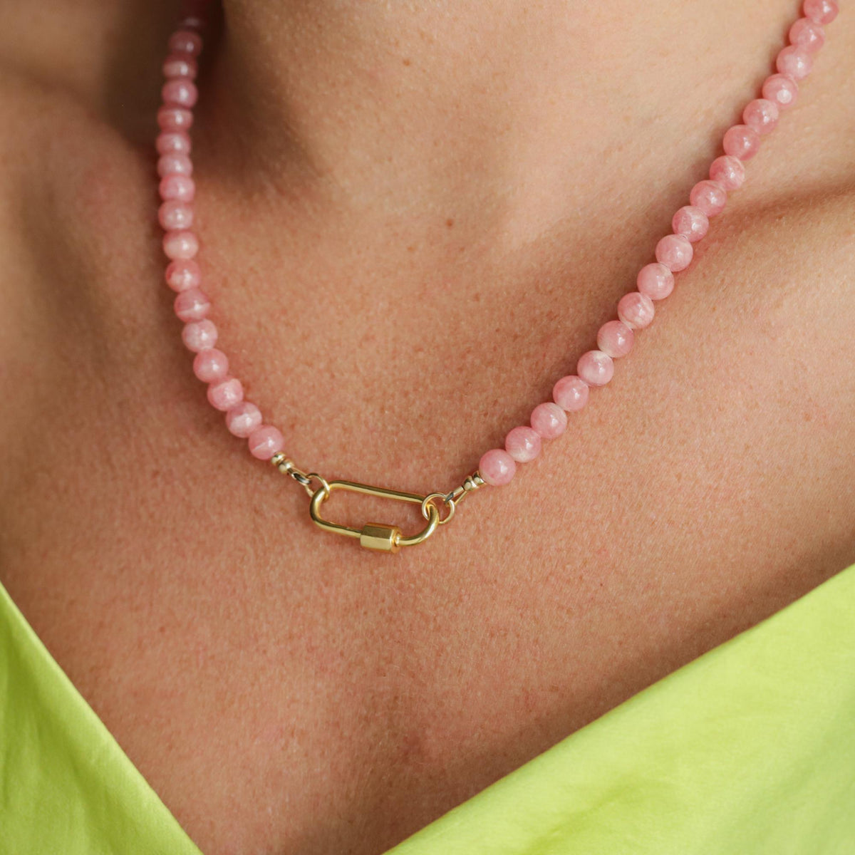 AAA+ Rhodochrosite Carabiner Necklace by Earthly Abundance featuring a polished pink rhodochrosite stone on a metal carabiner clip.