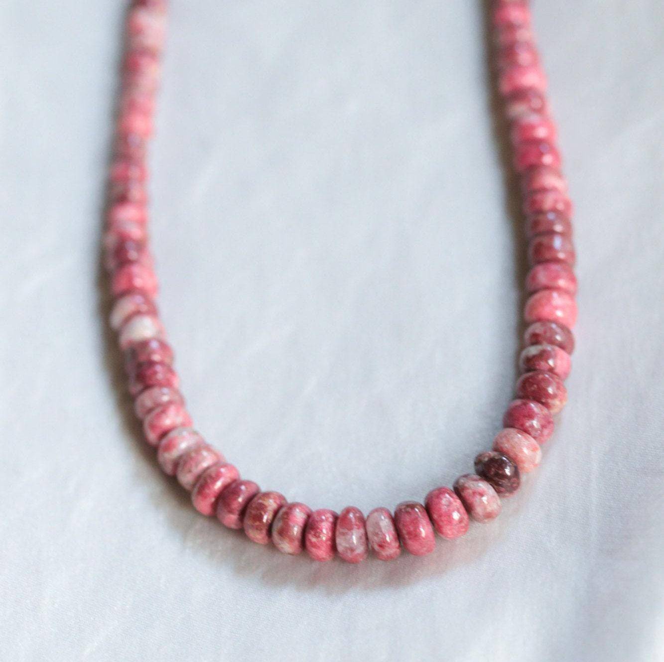Pink Thulite beaded necklace by Earthly Abundance featuring round pink stones on a delicate string.