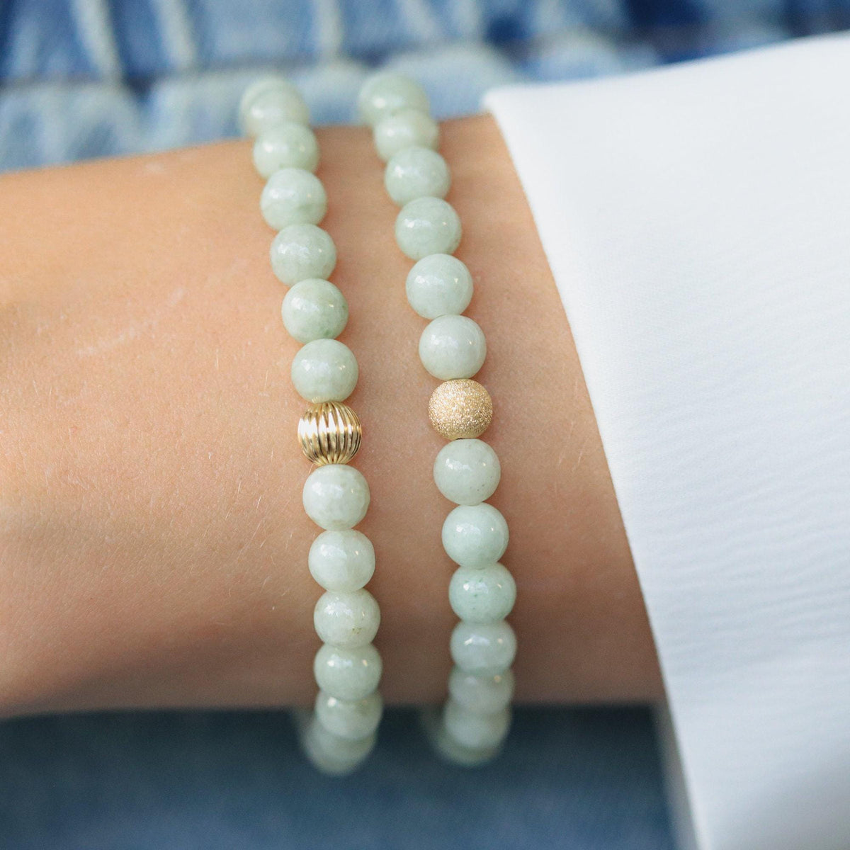 Smooth green Jadeite 6mm gemstone from Earthly Abundance Jewelry, showcasing polished, vibrant jade beads on a string.