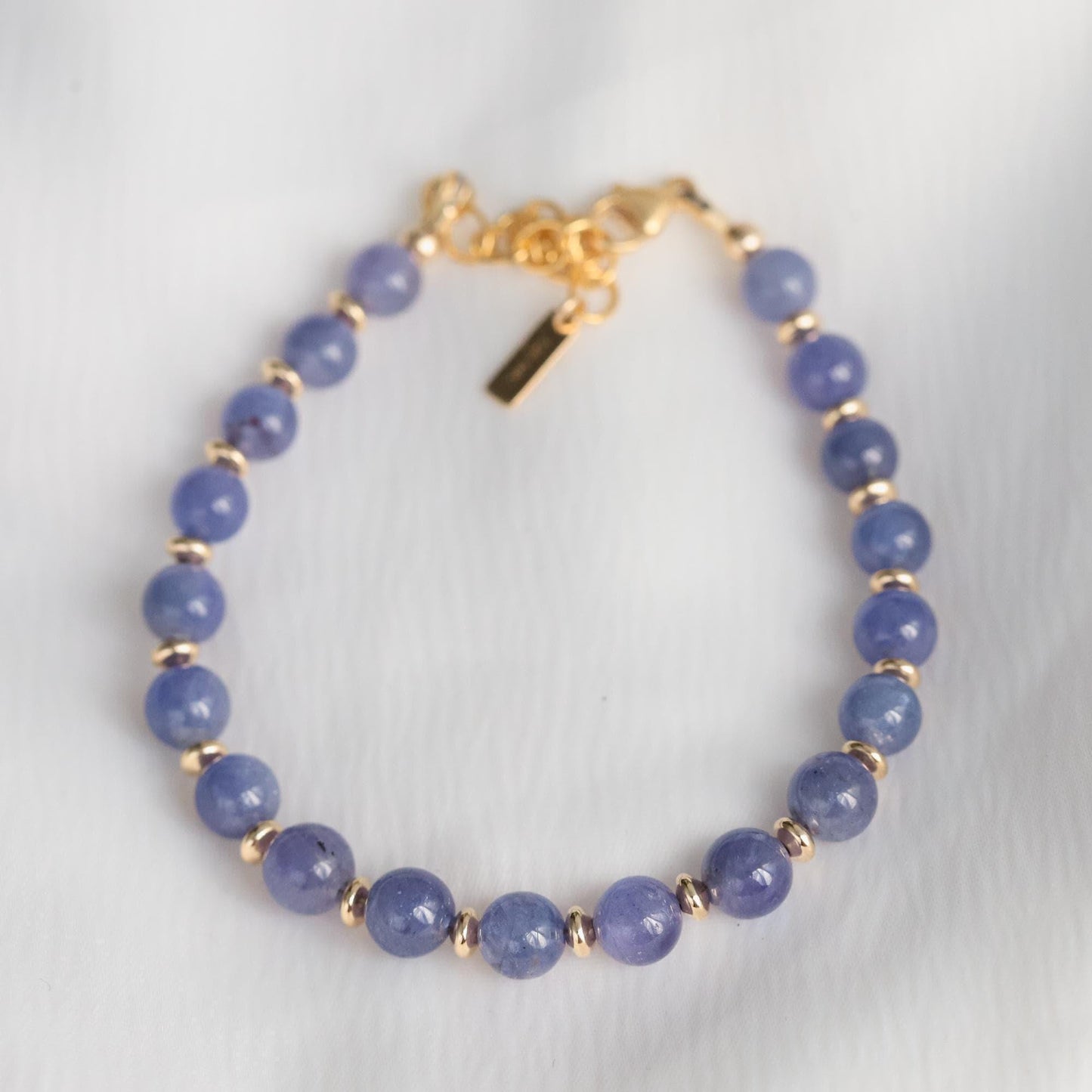Elegant Tanzanite bracelet by Earthly Abundance featuring deep blue-violet gemstones on a silver chain.