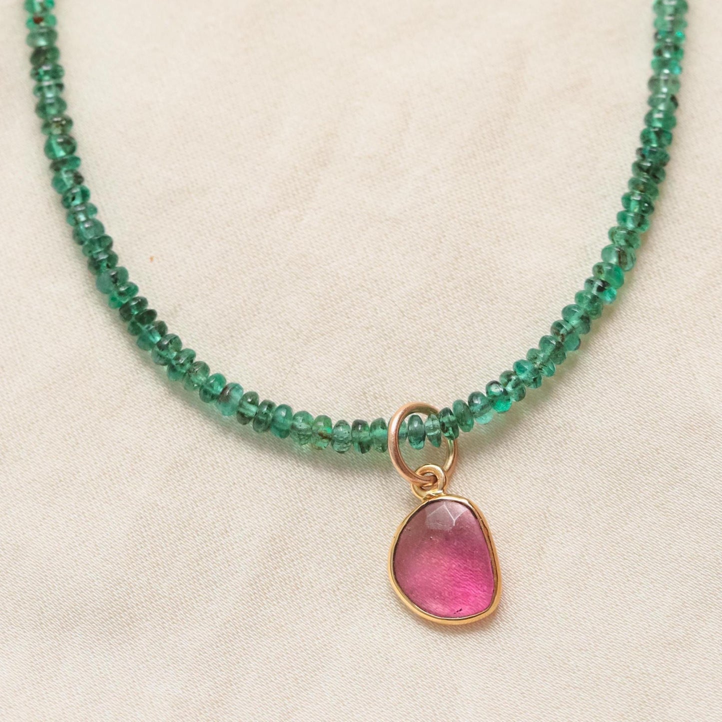Zambian emerald and pink tourmaline necklace featuring vibrant green and pink gemstones on a delicate chain, from Earthly Abundance.